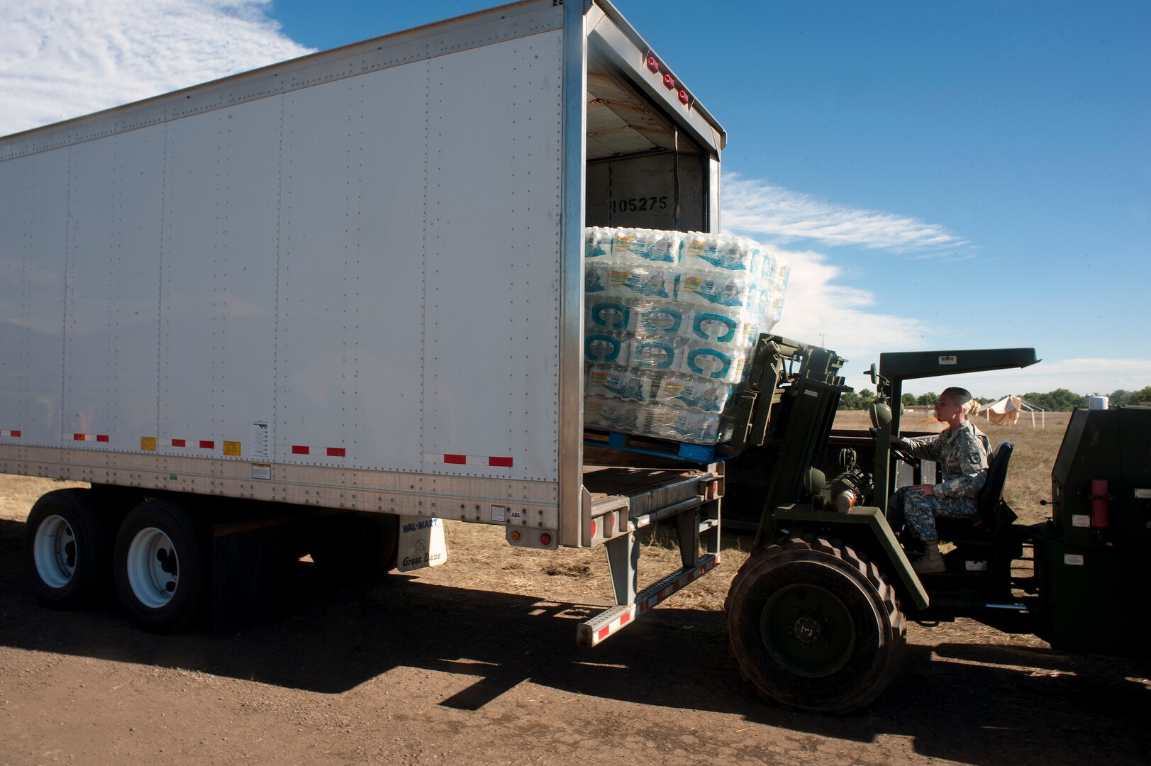 Army Staff Sgt. Lynda Santiago, a supply sergeant with the Colorado Army National Guard's Headquarters and Headquarters Company, 147th Brigade Support Battalion, uses a forklift to offload pallets of water as part of relief and recovery operations near Fort Collins, Colo., Wednesday, Sept. 18, 2013. More than 750 guard members have been working with local, state and federal authorities in response to flooding in central Colorado as a result of heavy rains in the area. Colorado Guard members have evacuated about 700 people by ground and military aerial evacuations currently total 2,394.