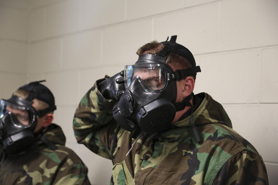 Marines break the seal on their gas mask exposing them to chlorobenzylidene malononitrile, or CS gas, during annual gas chamber training at the Chemical Biological Radiological Nuclear Training Facility aboard Marine Corps Air Station Beaufort, Sept. 12. CBRN training is designed to give Marines the knowledge needed to survive these attacks and gain confidence in their protective equipment.