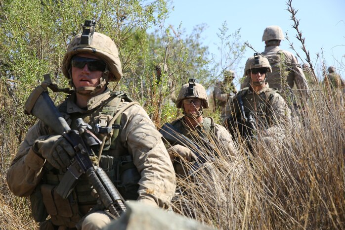 Marines with Fox Company, 2nd Battalion, 5th Marine Regiment, maintain security while on patrol during a combat readiness training exercise on Range 800 here, Sept. 12, 2013. The training helped the battalion see how multiple elements of an attack work together to accomplish a single mission. The training exercise prepared the Marines for future operations as well as combat.