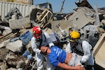 Search and extraction team members pull a "victim" from the rubble July 27, 2012 during Vibrant Response 13, a major incident exercise conducted by U.S. Northern Command and led by U.S. Army North. The team of Ohio National Guard members, are part of the Chemical, Biological, Radiological and Nuclear Enhanced Response Force Package, Homeland Response Force Region V.