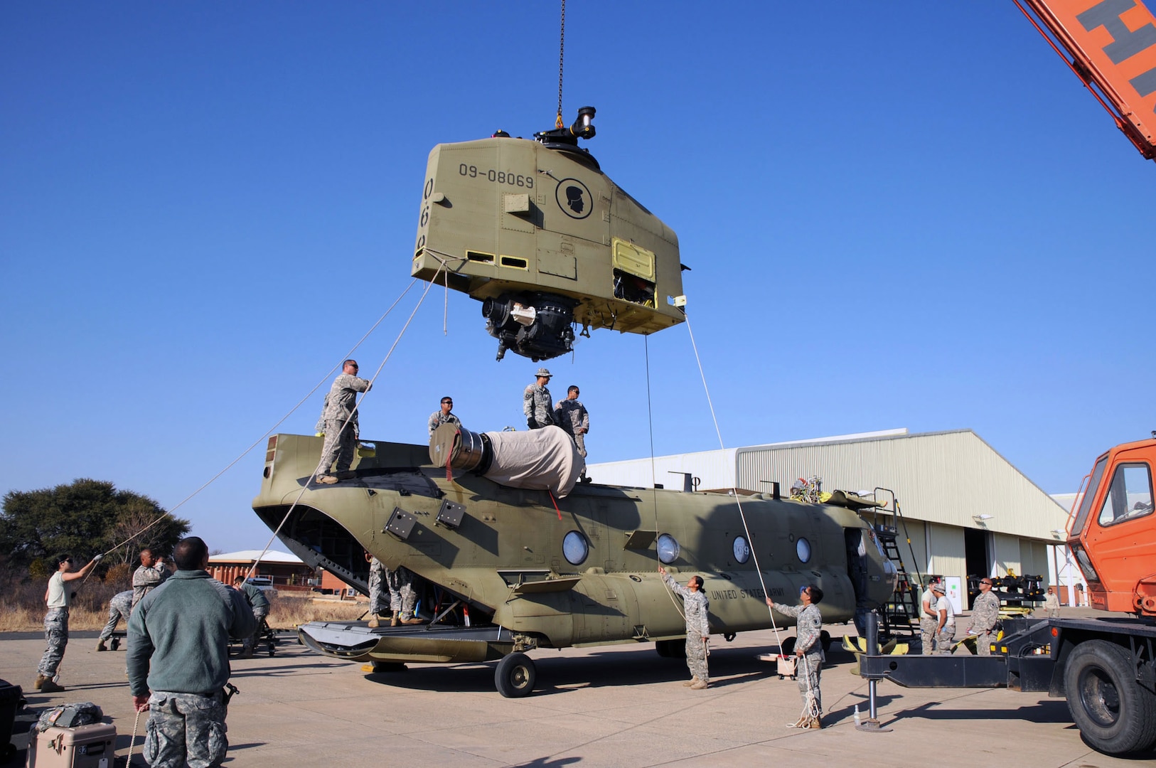 Soldiers of Hawaii Army National Guard's Bravo Company, 1-171st Aviation Regiment, based at Wheeler Army Airfield in Wahiawa, Hawaii, assemble the last of four Chinooks they transported to Botswana in support of Southern Accord 12. SA 12 brings together U.S. military personnel with their Botswana Defense Force counterparts to enhance military capabilities and interoperability.