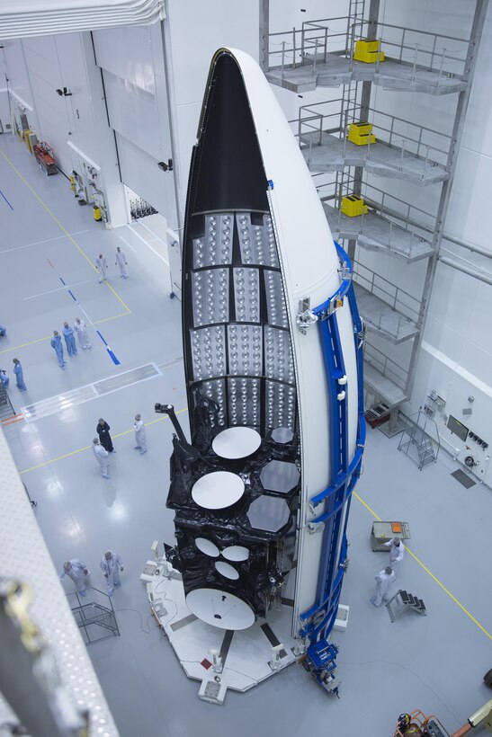 Workers prepare the Air Force's third Advanced Extremely High Frequency satellite for launch Sept. 12, 2013, near Cape Canaveral Air Force Station, Fla. The space vehicle was encapsulated into its fairing Aug. 27, 2013, before being mated to an Atlas V rocket. It was scheduled to launch Sept. 18, 2013. AEHF is a joint-service system that provides survivable, near worldwide, secure, protected, and jam-resistant communications for high-priority national military operations. (Courtesy photo/Lockheed Martin) 