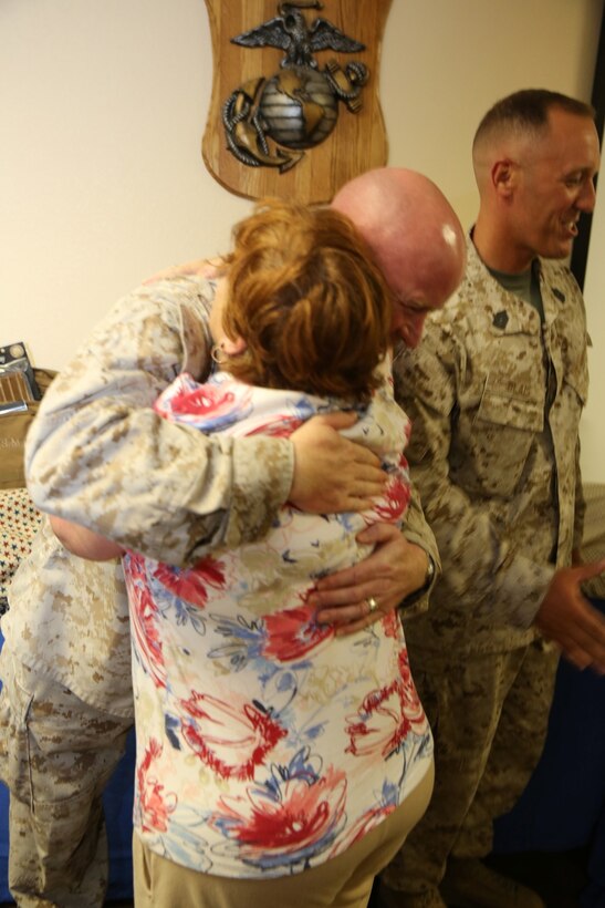 Meri Walker, a volunteer organizer and quilter with the Quilts of Valor, gives Master Sgt. Frank Omarah, base inspector on Marine Corps Logistics Base Barstow, Calif., a hug during MCLB Barstow's Welcome Home Heroes ceremony, Sept. 10. The Quilts of Valor helped sponsor the event and made quilts for Marines who have recently returned home from a tour overseas.