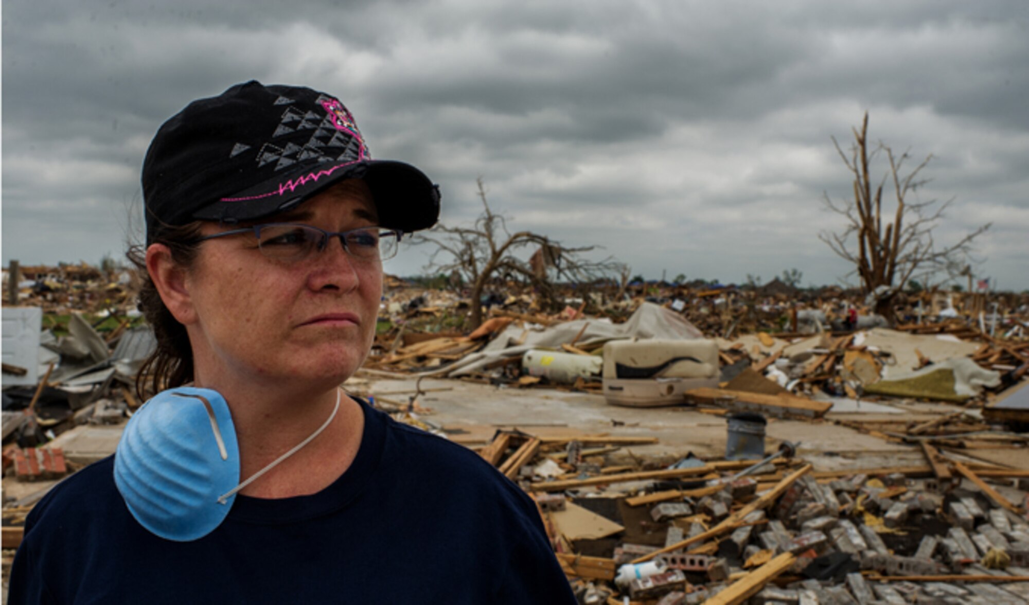 From the remnants of her former home, May 27, 2013, Tech. Sgt. Rhonda Stockstill surveys the devastation left in the wake of an EF-5 tornado that ripped through her neighborhood of Moore, Okla., on May 20. Soon after the storm passed, Stockstill rushed to provide aid to students and faculty injured and trapped in nearby Briarwood Elementary School. Stockstill is a surgical technician with the 72nd Medical Group at Tinker Air Force Base, Okla. (U.S. Air Force photo/Staff Sgt. Jonathan Snyder)