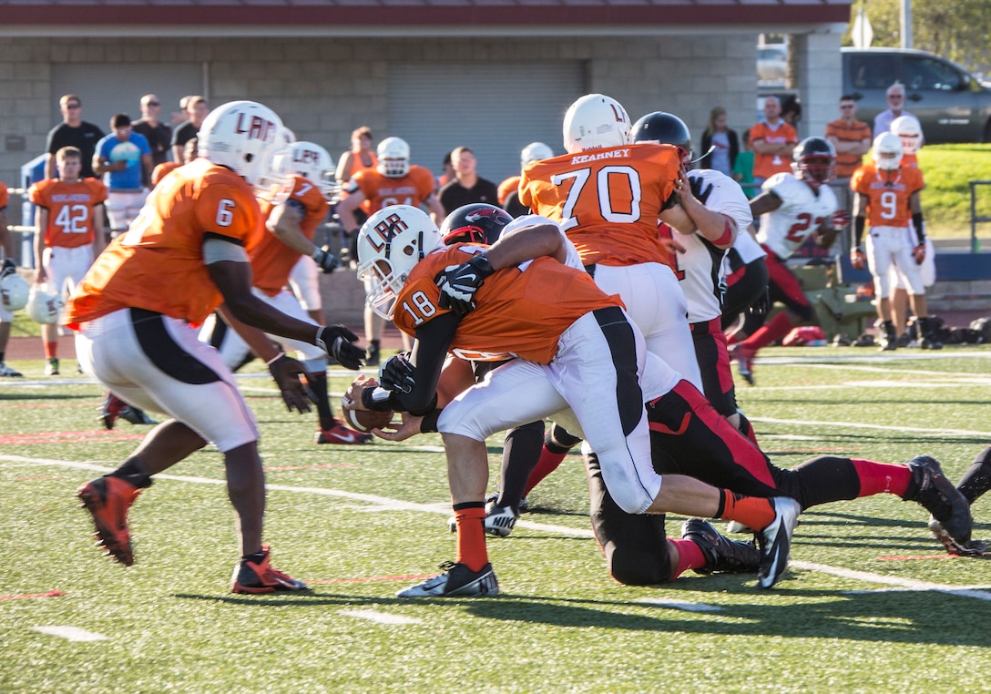 Bryan Mack, a defensive tackle with the Marine Corps Air Station Miramar Falcons, sacks the quarterback during a game against the 1st Light Armored Reconnaissance Battalion Highlanders at the Paige Field House aboard Marine Corps Base Camp Pendleton, Calif., Sept. 17.  The Falcons won the game with a final score of 25-21. 