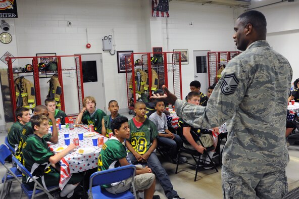 Senior Master Sgt. Dorian Dillon, 35th Civil Engineer Squadron superintendent of fire emergency services, speaks to members of the Edgren High School football team at Misawa Air Base, Japan, Sept. 19, 2013. Firefighters from the 35 CES hosted a mentorship dinner for the players where they spoke to them about teamwork before their matchup with rivals from American School in Japan. (U.S. Air Force photo by Senior Airman Derek VanHorn)