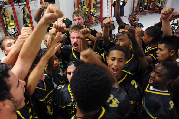 Members of the Edgren High School football team huddle together after a mentorship dinner at the fire station at Misawa Air Base, Japan, Sept. 19, 2013. Firefighters from the 35th Civil Engineer Squadron hosted the event to share insight on the elements and importance of teamwork both in football and in life. (U.S. Air Force photo/Senior Airman Derek VanHorn)
