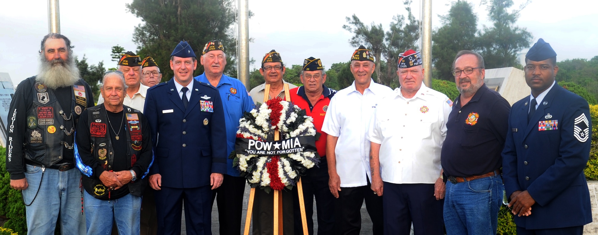 U.S. Air Force Brig. Gen. James Hecker, 18th Wing commander, and Chief Master Sgt. Phillip Easton, 18th Mission Support Group superintendent, stand with veterans after the POW/MIA flag ceremony on Kadena Air Base, Japan, Sept. 20, 2013. National POW/MIA Remembrance Day is observed across the nation on the third Friday of September each year. It honors those who were prisoners of war and those who are still missing in action. (U.S. Air Force photo by Naoto Anazawa)


