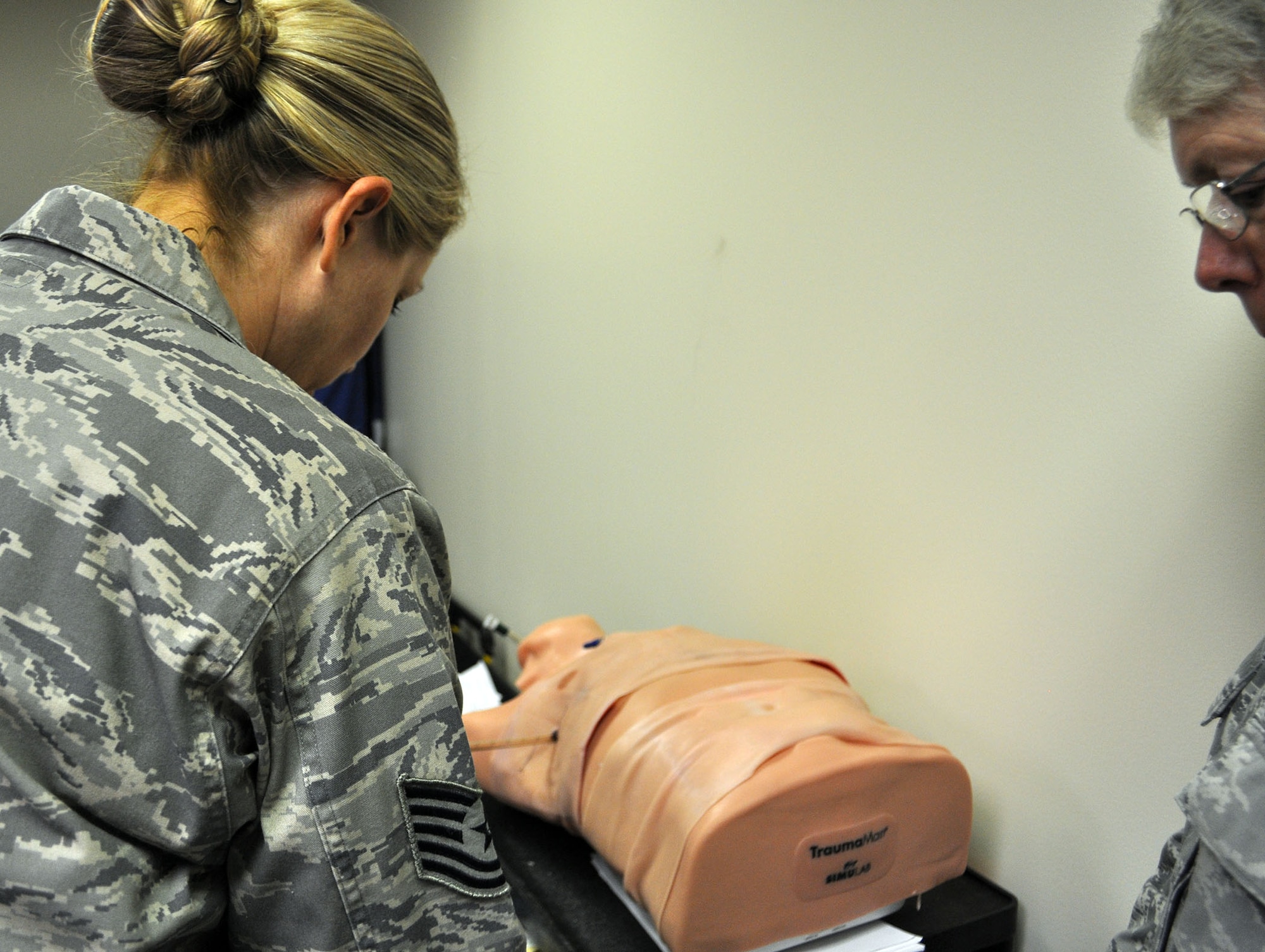 TRAVIS AIR FORCE BASE, Calif. -- Medical Technician, Tech. Sgt. Bobi Skogen, talks about chest tubes and insertion with her instructor. During the Sept. 7 and 8 “Super” unit training assembly weekend for the 349th Air Mobility Wing, Reserve doctors, nurses, and medical technicians, were able to use the center to train on procedures and skills they use less often. (U.S. Air Force photo/Ellen Hatfield)