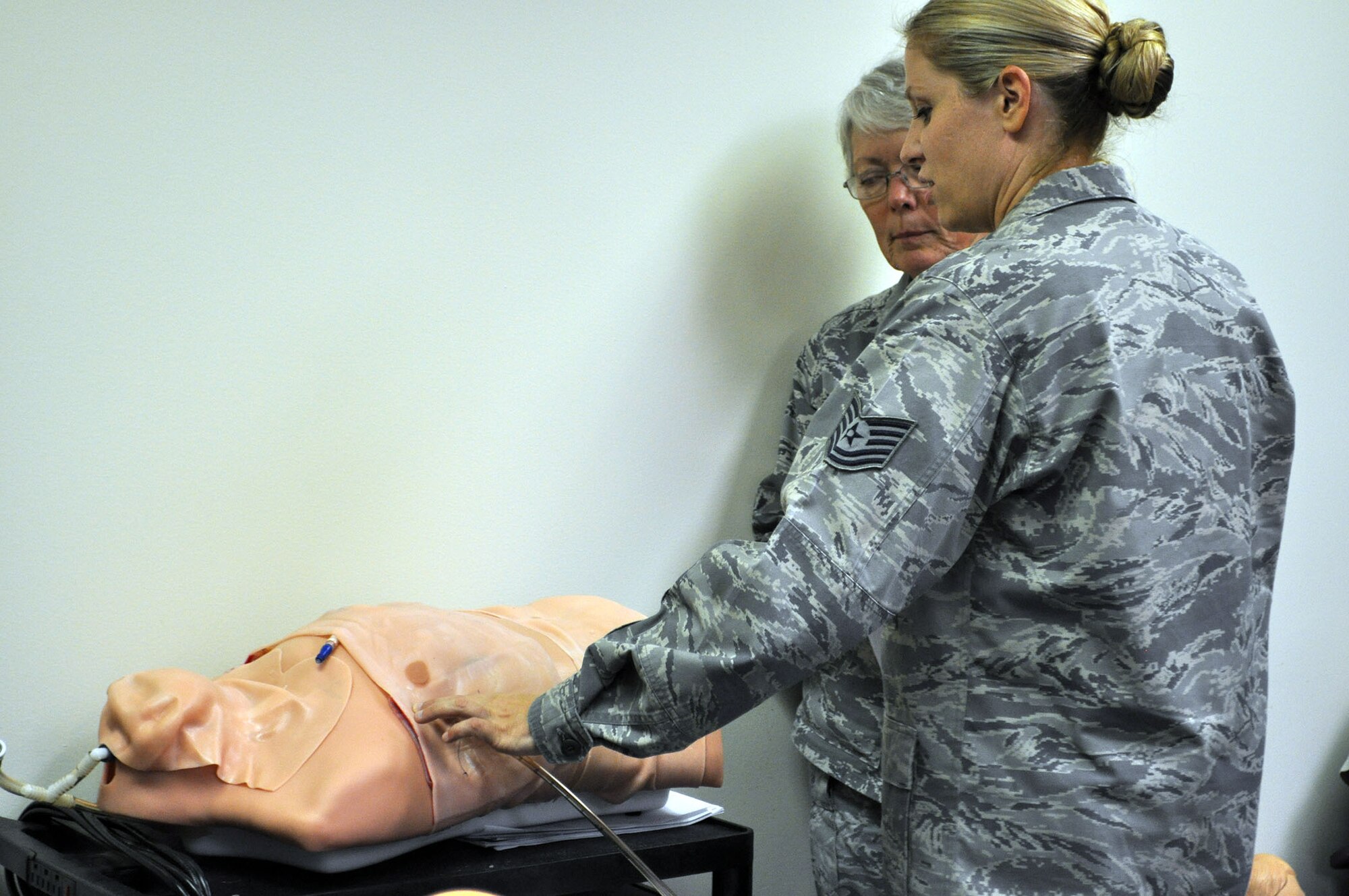 TRAVIS AIR FORCE BASE, Calif. -- Medical Technician, Tech. Sgt. Bobi Skogen, talks about chest tubes and insertion with her instructor. During the Sept. 7 and 8 “Super” unit training assembly weekend for the 349th Air Mobility Wing, Reserve doctors, nurses, and medical technicians, were able to use the center to train on procedures and skills they use less often. (U.S. Air Force photo/Ellen Hatfield)