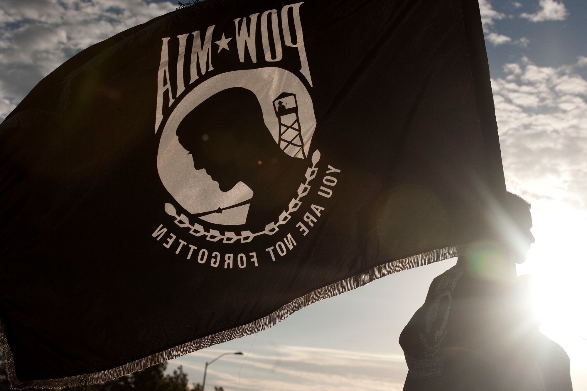 ALTUS AIR FORCE BASE, Okla. – U.S. Air Force Chief Master Sgt. Bryan Creager, 97th Air Mobility Wing command chief, leads a remembrance run while holding the prisoners of war and missing in action flag during the third annual POW/MIA Remembrance Ceremony at the Wings of Freedom Park Sept. 19. On August 10, 1990, the 101st Congress passed U.S. Public Law 101-355, which recognized the POW/MIA flag and designated it as the symbol of the United States’ concern and commitment to resolving the fates of Americans still prisoner, missing and unaccounted for. (U.S. Air Force photo by Senior Airman Jesse Lopez/Released)