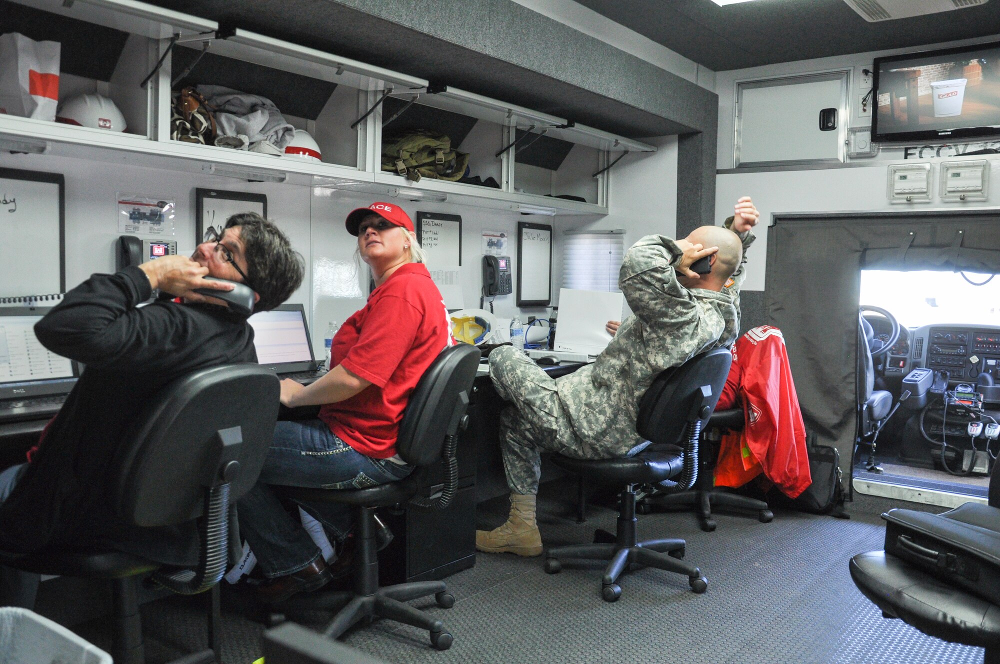 Army Corps of Engineers employees field calls during Colorado flood relief efforts Sept. 17, 2013, at Buckley Air Force Base, Colo. Flood relief aid was needed after Colorado suffered up to 15 inches of rain that caused massive flooding across the Front Range. (U.S. Air Force photo by Staff Sgt. Nicholas Rau/Released)