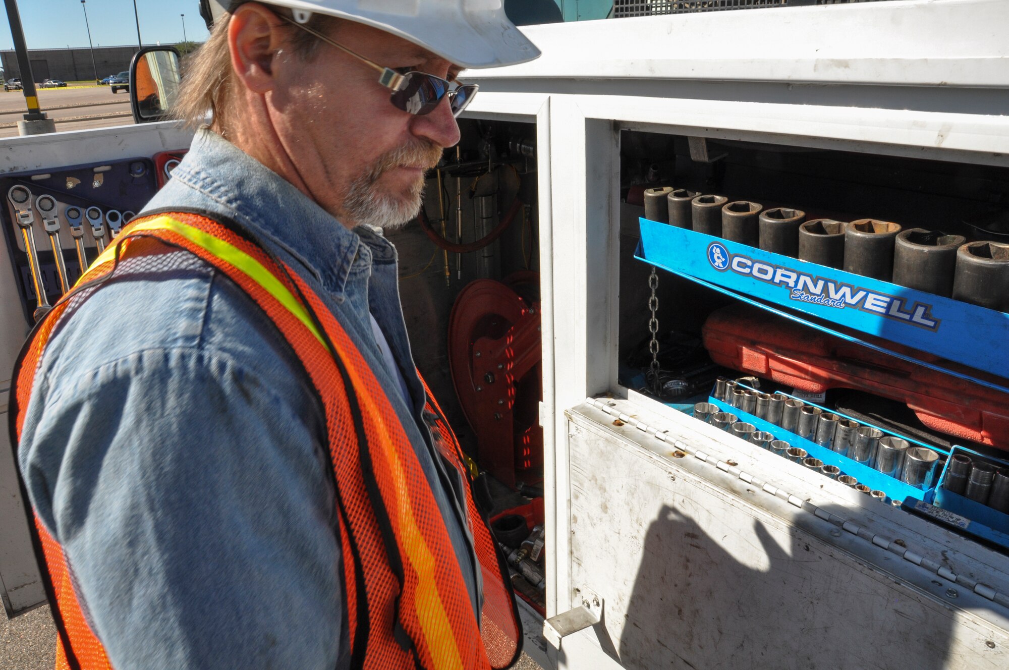 A contractor working with the Army Corps of Engineers inventories his tools before working on a generator Sept. 17, 2013, at Buckley Air Force Base, Colo. The contractors assisted with flood relief by fixing and maintaining generators that were used as aid during relief efforts after Colorado suffered up to 15 inches of rain that caused massive flooding across the Front Range. (U.S. Air Force photo by Staff Sgt. Nicholas Rau/Released)