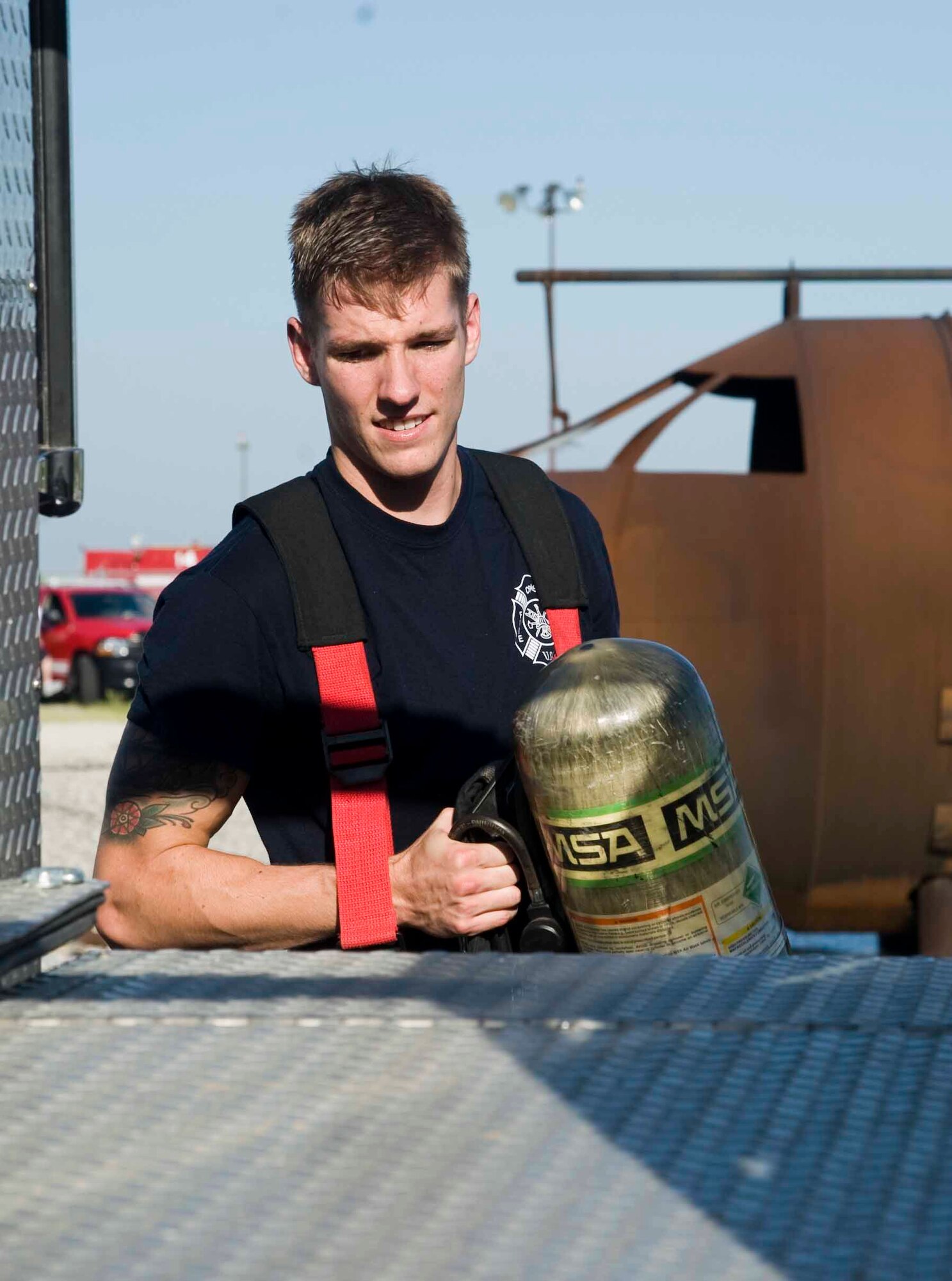 Senior Airman Christopher T. Hatch, 22nd CES firefighter and driver operator, services his self contained breathing apparatus pack after a live-fire training exercise Aug. 27, 2013, at McConnell Air Force Base, Kan. Base firefighters train to arrive at the scene of a base emergency within seven minutes. (U.S. Air Force photo/Airman 1st Class John Linzmeier)