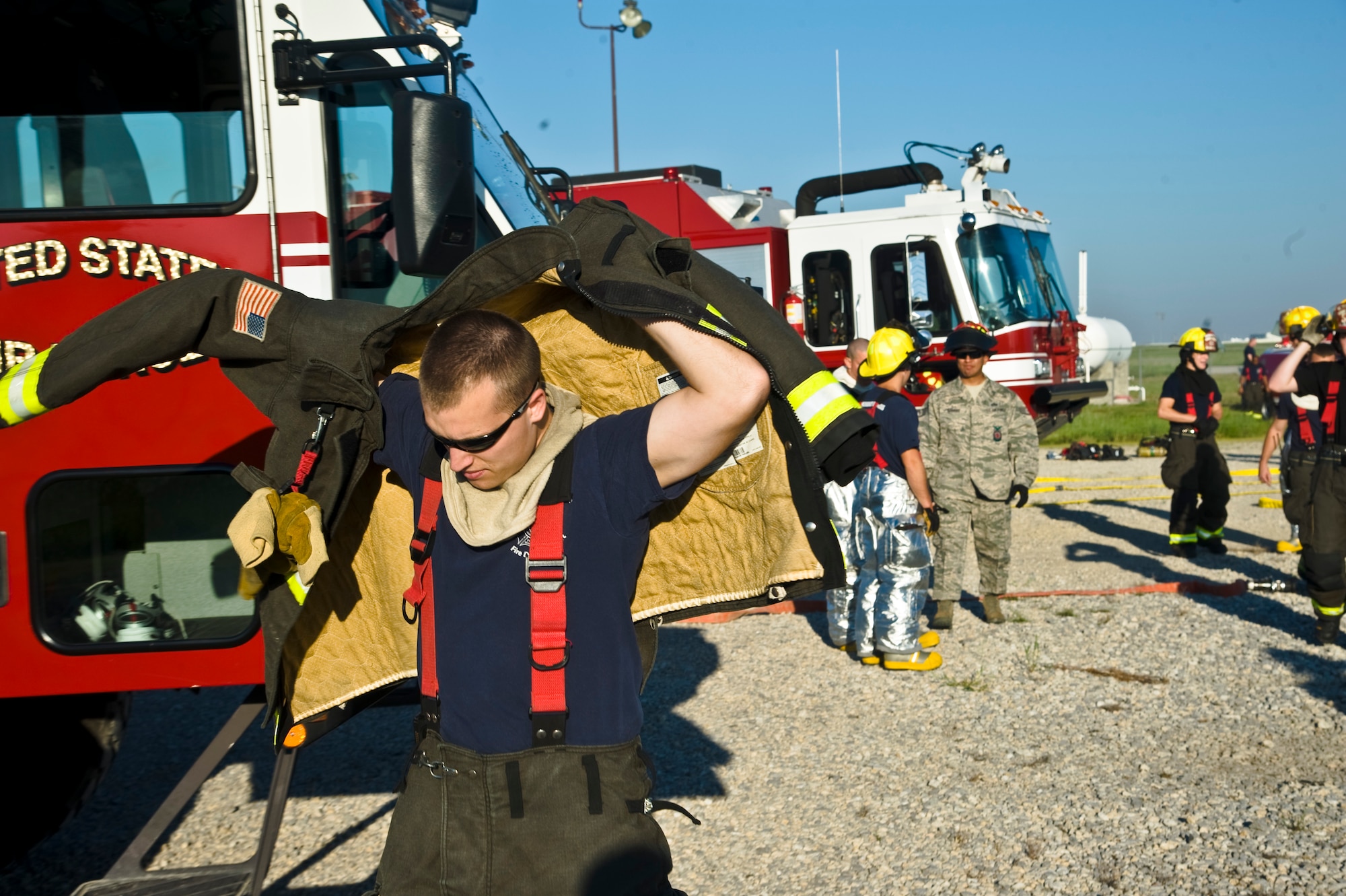 Staff Sgt. Greg Hoyt, 22nd Civil Engineering Squadron Fire Flight lead firefighter, dawns personal protective equipment in preparation for a live aircraft fire exercise Aug. 27, 2013, at McConnell Air Force Base, Kan. Each firefighter participates in live-fire training biannually to retain their proficiency in responding to real-world emergencies. (U.S. Air Force photo/Airman 1st Class John Linzmeier)