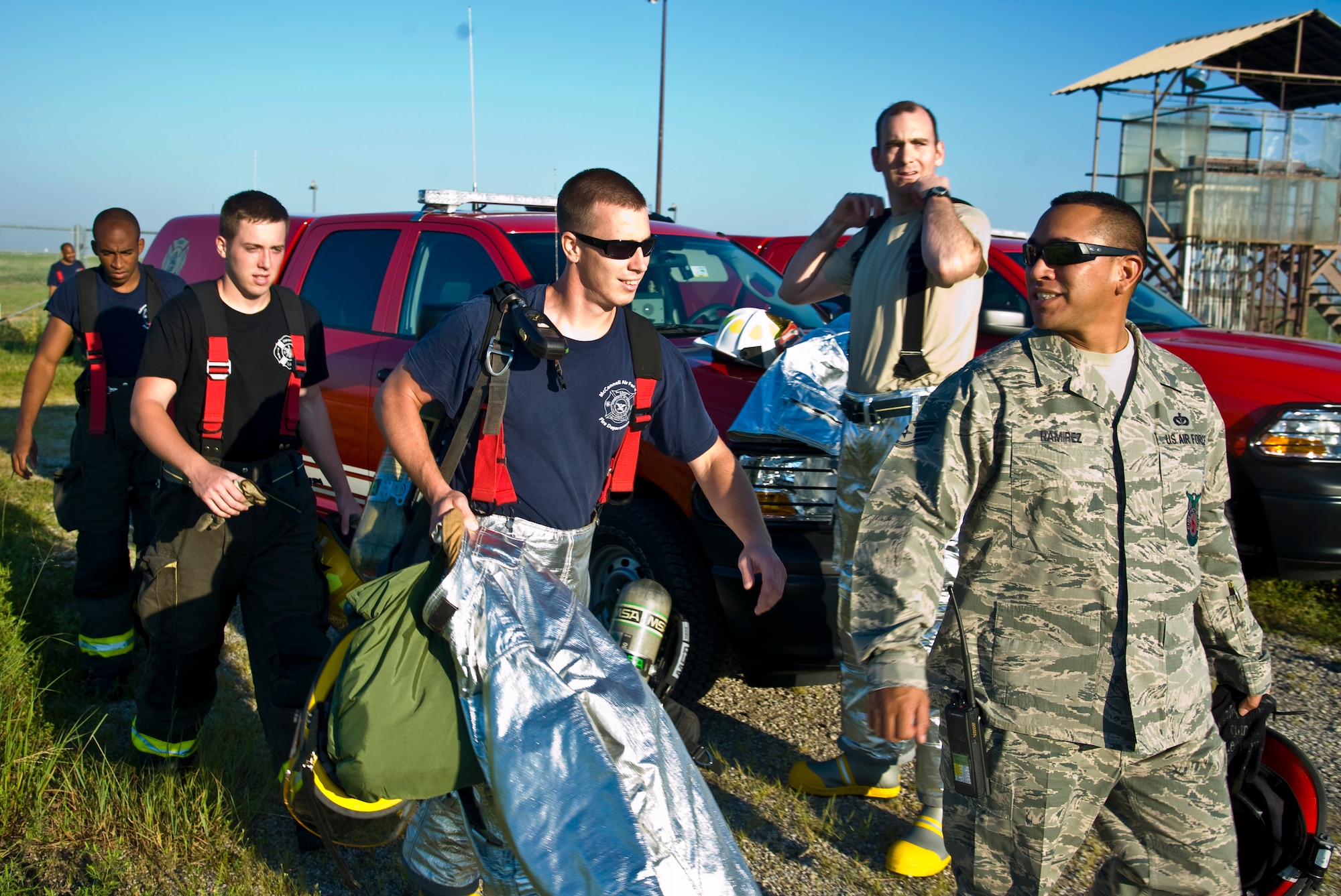 Firefighters from the 22nd Civil Engineering Squadron approach a fire trainer aircraft for a live fire exercise Aug. 27, 2013, at McConnell Air Force Base, Kan. Squadron Leadership participated in the exercise to experience how firefighters prepare and respond to emergencies. (U.S. Air Force photo/Airman 1st Class John Linzmeier)