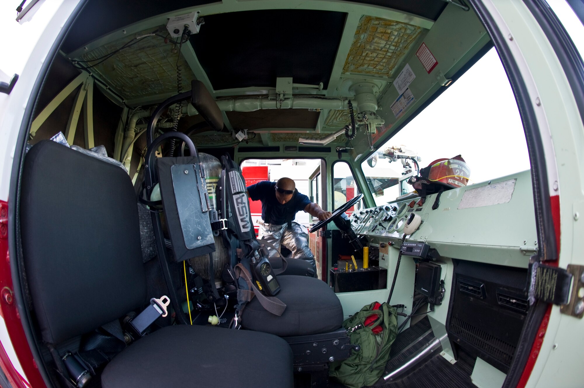 Stevan Taylor, 22nd Civil Engineering Squadron firefighter and driver operator, enters the driver’s seat of a P-19 airport rescue fire fighting vehicle before a live fire training exercise Aug. 27, 2013, at McConnell Air Force Base, Kan. 22nd CES firefighters are expected to dawn their personal protective equipment and respond to an emergency within seven minutes or less. They often times exceed their time requirements while still abiding safety precautions. (U.S. Air Force photo/Airman 1st Class John Linzmeier)