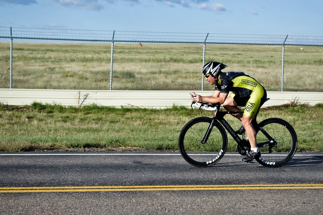 Dave Warfield, Buckley Health and Wellness Center, bikes along Steamboat Avenue during the 2nd Annual Buckley Duathlon Sept. 19, 2013, on Buckley Air Force Base, Colo. The race started with a 2-mile run, followed by a 6-mile bike ride and finished with a 1.5-mile run. (U.S. Air Force photo by Airman 1st Class Riley Johnson/Released)