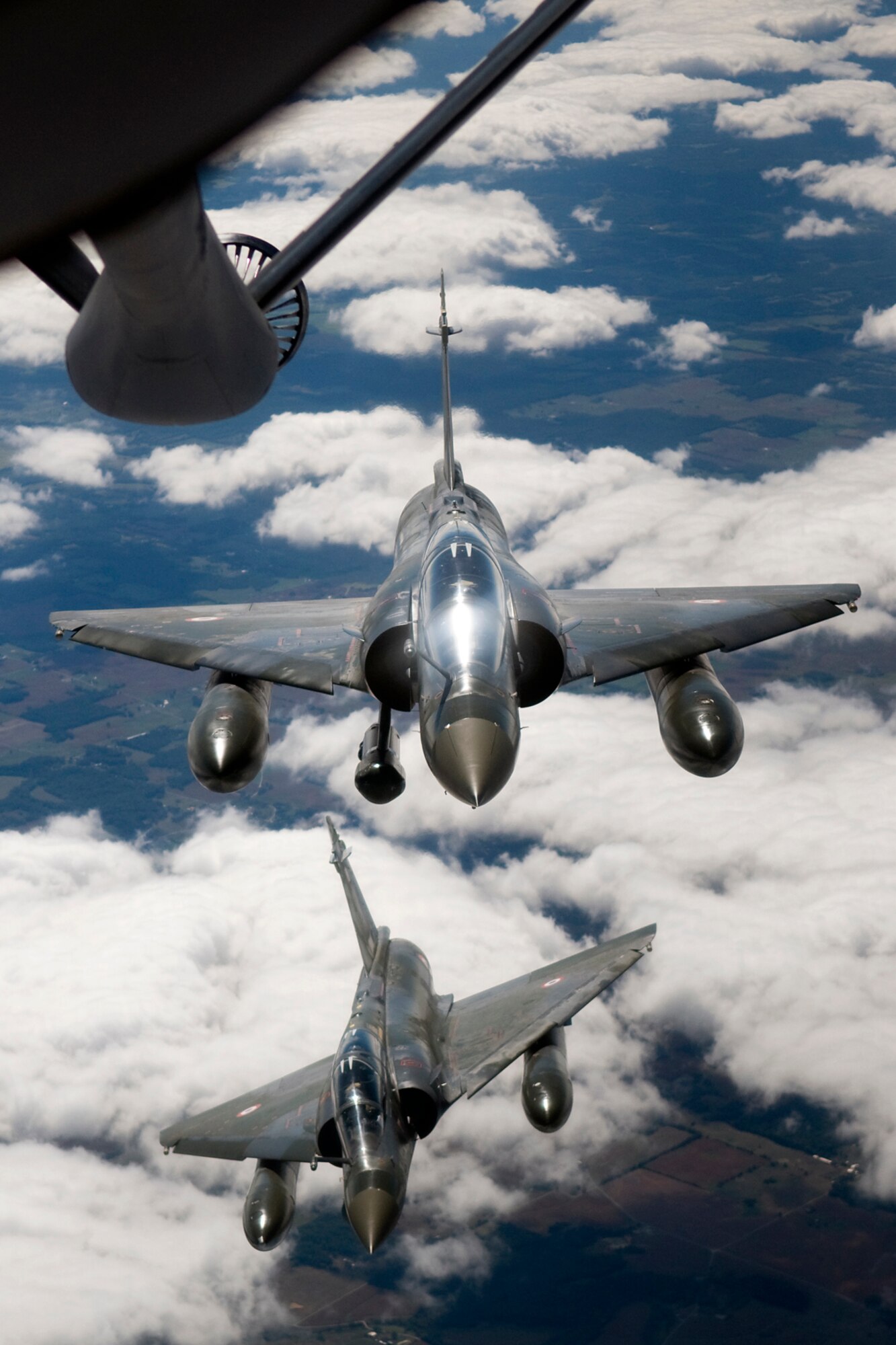 Two French Air Force Mirage 2000Ds line up in formation behind a U.S. Air Force KC-135R Stratotanker after an in-flight refueling mission over southern Indiana Sept. 13, 2013. The KC-135 and its crew were from the 434th Air Refueling Wing at Grissom Air Reserve Base, Ind., the Mirages were assigned to the Fighter and Experimentation Squadron 05.330. (U.S. Air Force photo/Tech. Sgt. Mark R. W. Orders-Woempner) 
