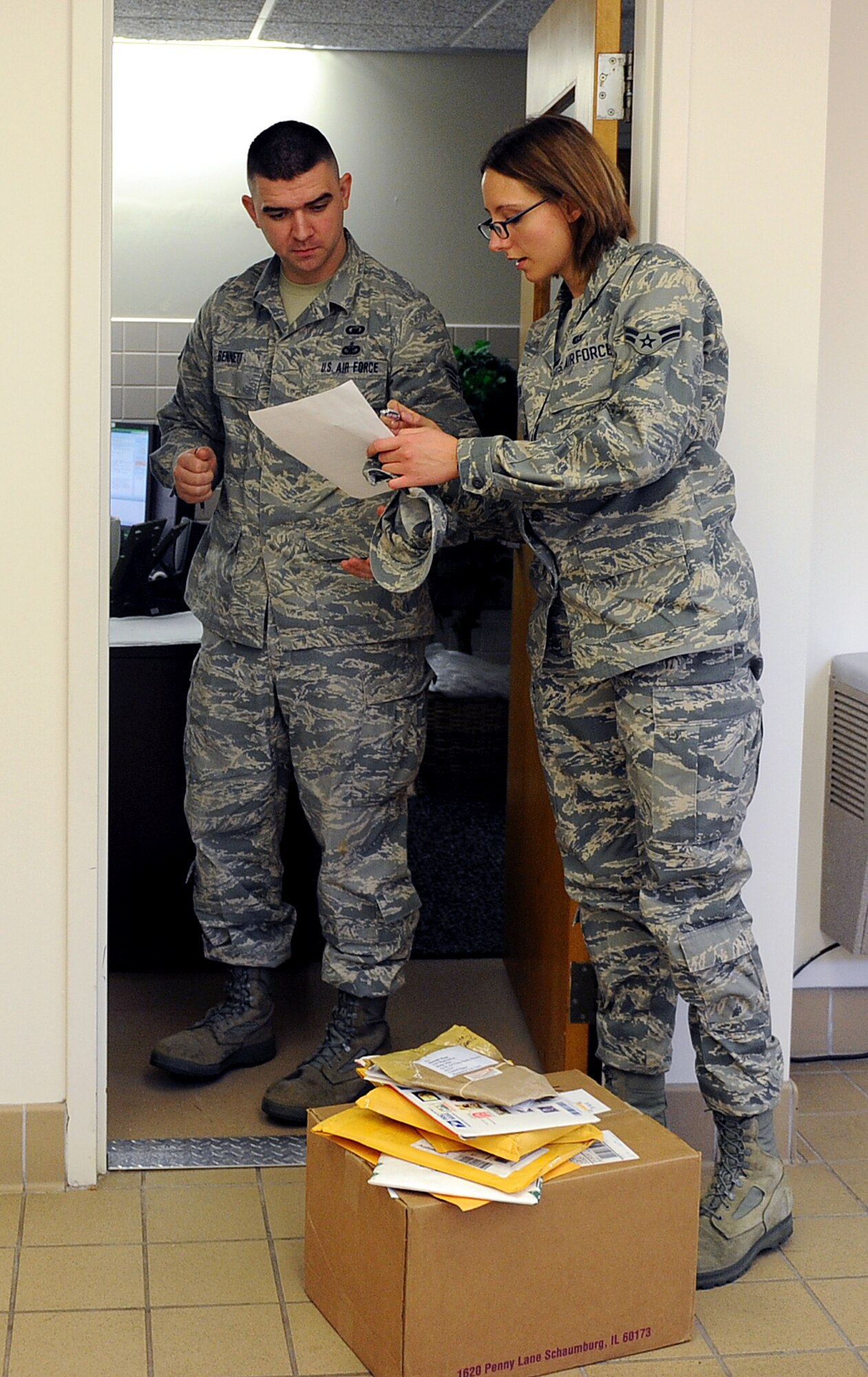 Airman 1st Class Rhiannon Smith delivers mail to Staff Sgt. Thomas Bennett at the chapel Sept. 5, 2013, Scott Air Force Base, Ill. Smith is a knowledge operator assigned to the 375th Communications Squadron, and Bennett is a chaplain's assistant assigned to the 375th Air Mobility Wing. (U.S. Air Force photo/Airman 1st Class Jaeda Waffer)