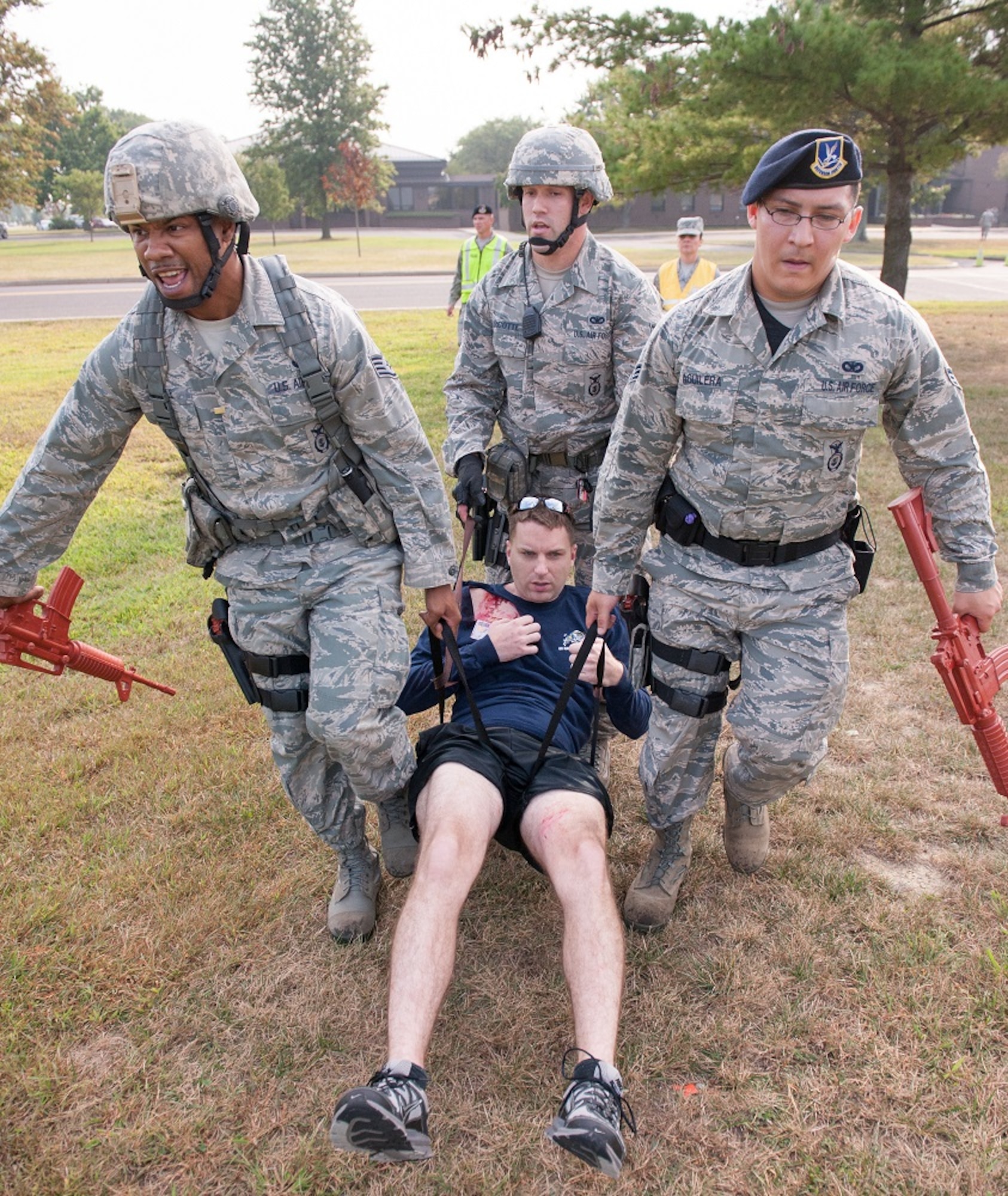Service members from the 87th Security Forces Squadron carry a simulated wounded victim during an active-shooter exercise Sept. 12, 2013, at Joint Base McGuire-Dix-Lakehurst. The active-shooter exercise tested the threat response time and effectiveness of JB MDL first responders. (U.S. Air Force photo by Carlos Cintron/Released) 