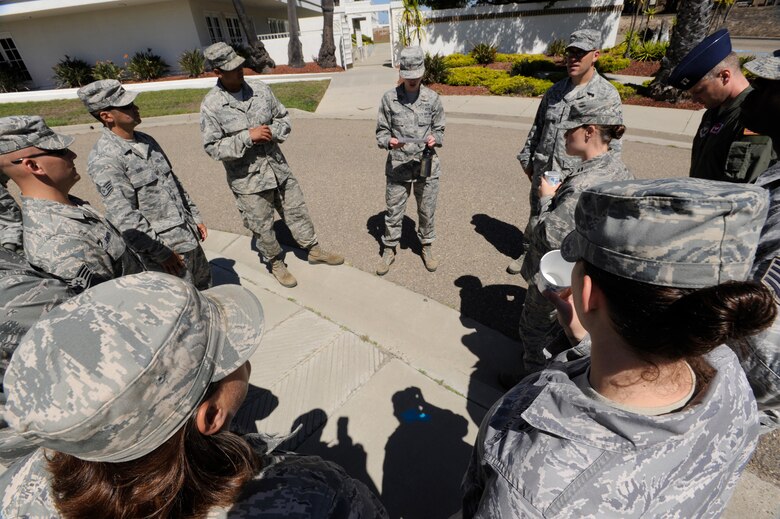 VANDENBERG AIR FORCE BASE, Calif. -- Members of a 30th Civil Engineer Squadron team form a circle at a rest station to discuss the importance of "Respect" in preventing sexual assault during the "Get R.E.A.L. Walk" here Tuesday, Sept. 17. During the walk, which was hosted by the 381st Training Group, Team V members were asked to change the culture and pledge their commitment to preventing sexual assaults by signing banners representing Respect, Equality, Accountability and Leadership. (U.S. Air Force photo/Airman Yvonne Morales)