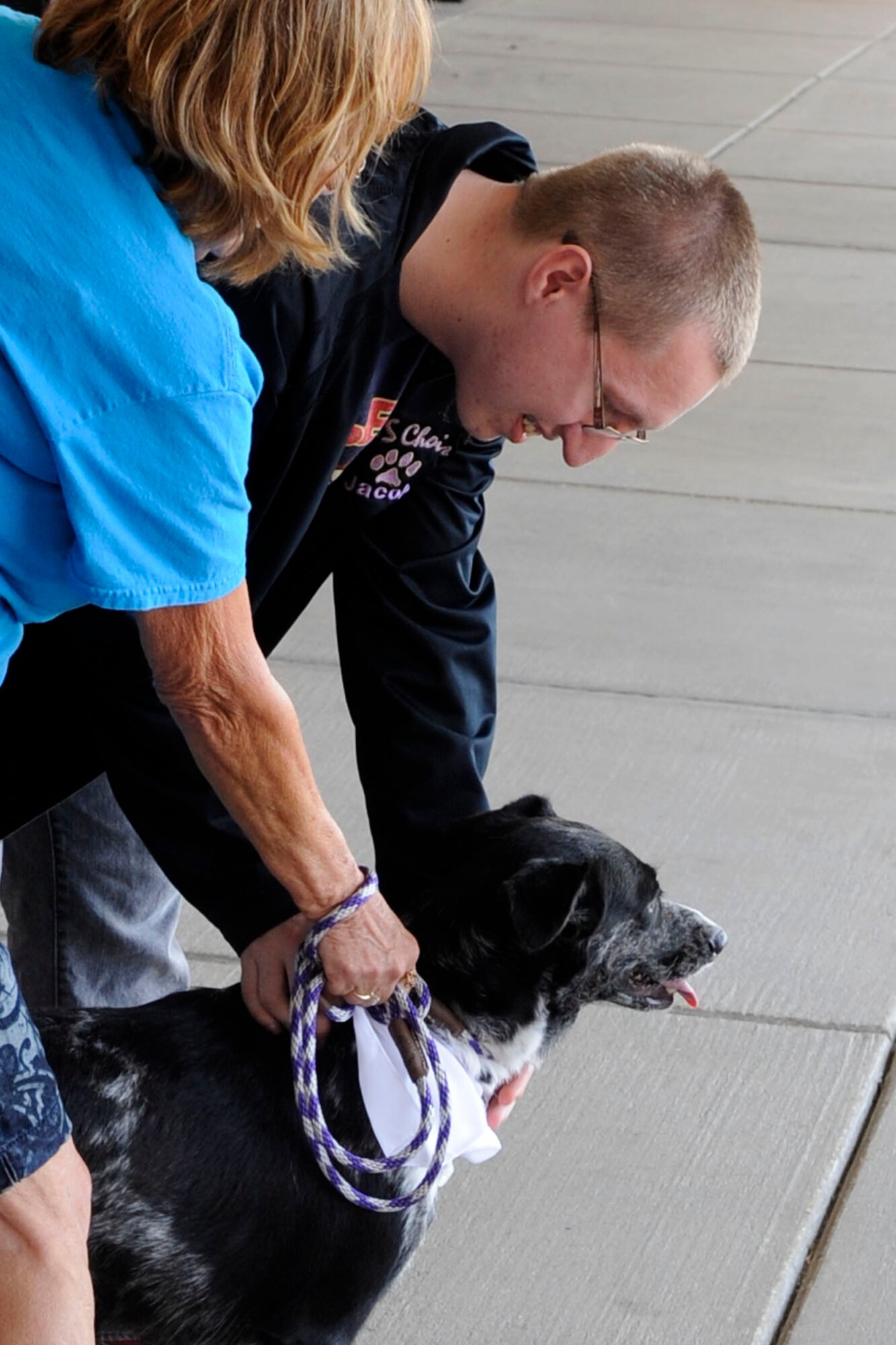 With the assistance of Pam Cantley, a volunteer for the Humane Society of Northwest Louisiana, Jacob Miller gets to know Lilly during a Humane Society of Northwest Louisiana adoption event at the Barksdale Exchange on Barksdale Air Force Base, La., Sept. 14, 2013. Jacob is the son of Tech. Sgt. Bonnie Miller, 2nd Force Support Squadron. HSNWL reported that the event was one of their most successful, with 10 of the 15 animals brought to the event being adopted. (U.S. Air Force photo by Master Sgt. Jeff Walston/Released)