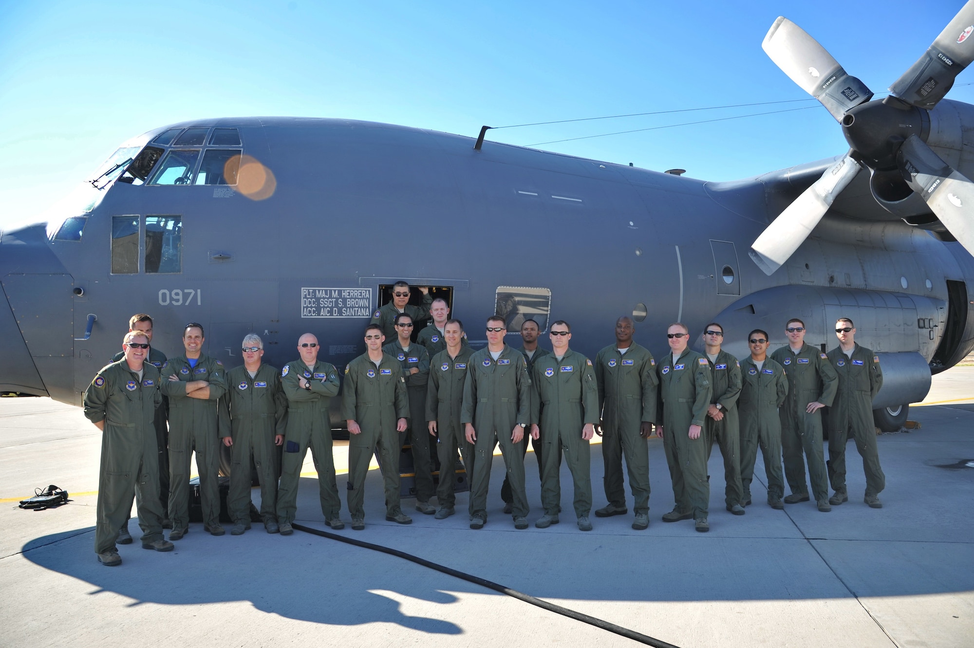 Crew members pose before one of the 550th Special Operations Squadron's last two remaining assigned MC-130Ps Combat Shadows as it sits on the flightline before its final flight at an informal ceremony Sept. 6.  The departure of the aircraft marks the end of a 25-year training curriculum at Kirtland. (Photo by Ken Moore)