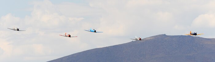 T-6 Texan aircraft race for position during the 50th Annual National Championship Air Races at Stead Airport, Reno, Nev., Sept. 14, 2013. These aircraft were used as trainers for the U.S. military for decades. (U.S. Air Force photo by Staff Sgt. Robert M. Trujillo/Released)
