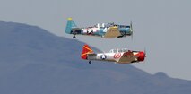 Two T-6 Texan aircraft race for position during the 50th Annual National Championship Air Races at Stead Airport, Reno, Nev., Sept. 14, 2013. These aircraft were used as trainers for the U.S. military for decades. (U.S. Air Force photo by Staff Sgt. Robert M. Trujillo/Released)