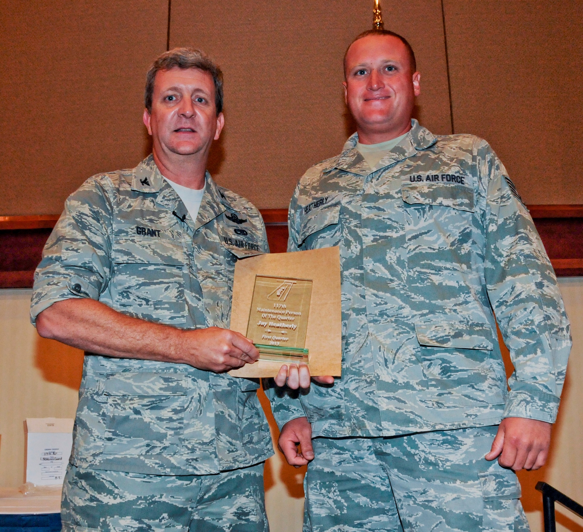 BIRMINGHAM, Ala. -- Col. Scott Grant, the 117th Maintenance Group Commander, presents Tech. Sgt. Jay G. Heatherly the Maintenance Person of the Quarter award here on Aug. 11. (U.S. Air National Guard photo by Airman 1st Class Wesley A. Jones/Released)