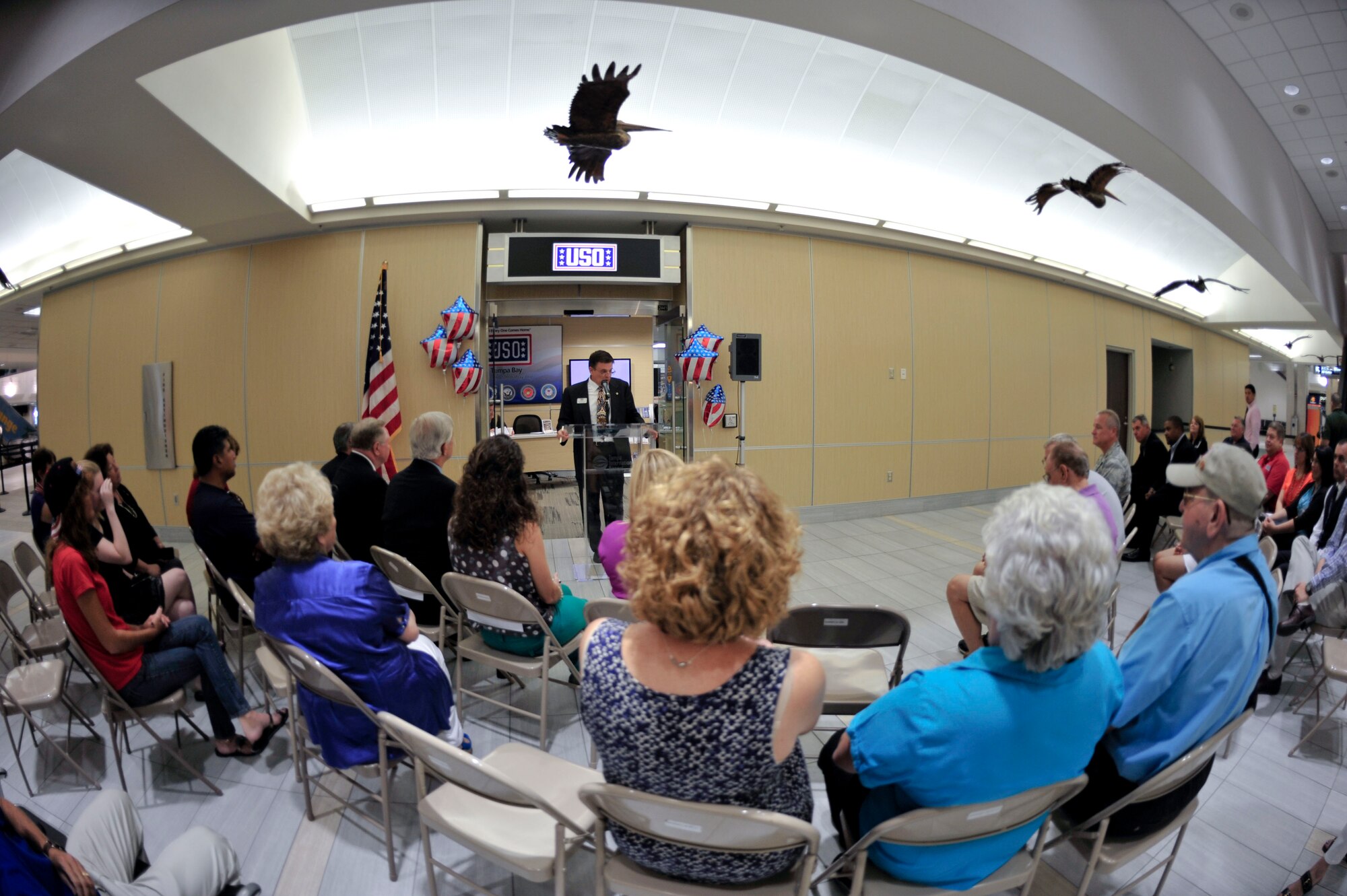 Michael Rovinelli, USO Tampa Bay, Inc. executive director, tells an audience at the Tampa International Airport about the organization during its year anniversary celebration Sept. 6, 2013. The USO was opened in the TIA last year due to the high population of military members living in the area and travelling through the airport. (U.S. Air Force photo by Airman 1st Class Sarah R. Hall-Kirchner/Released)