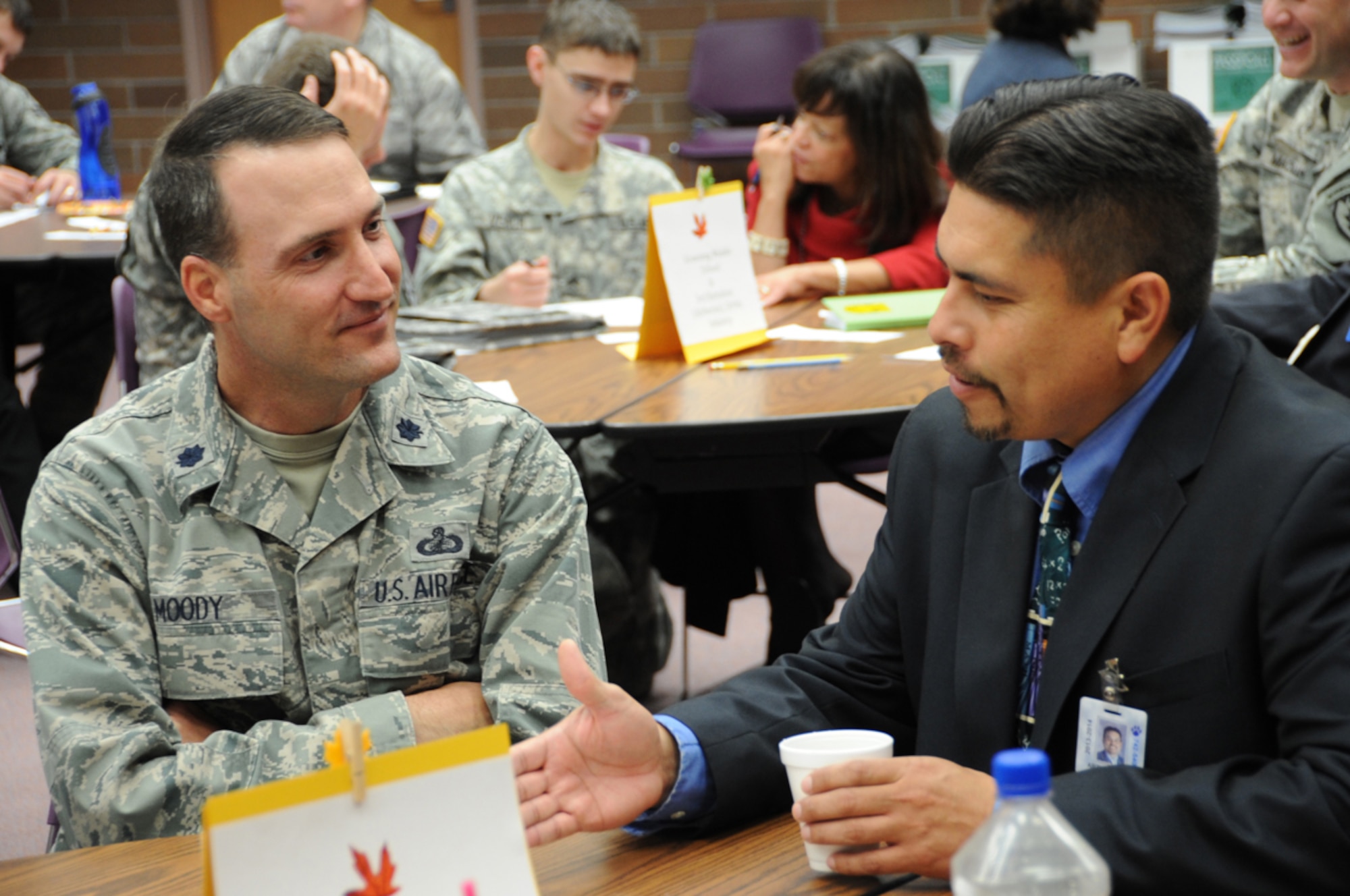 Air Force Lt. Col. Jeffry Moody, 673d Contracting Squadron commander, discusses events for the School Partnership program with Arthur Sousa, Abbott Loop Elementary principal, at the King Career Center of Anchorage, September 12.  The School Partnership Program is a program to help motivate and tutor students. (U.S. Air Force Photo/Airman 1st Class Omari Bernard)