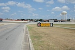 The Joint Base San Antonio-Randolph south taxiway’s intersection with Golf Road, located just north of Randolph Oaks Golf Course, is a dangerous crossroads, which requires motorists and pedestrians to stop as directed at the intersection. (U.S. Air Force photo by Don Lindsey/ Released)