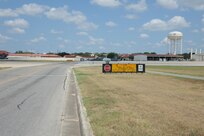 The Joint Base San Antonio-Randolph south taxiway’s intersection with Golf Road, located just north of Randolph Oaks Golf Course, is a dangerous crossroads, which requires motorists and pedestrians to stop as directed at the intersection. (U.S. Air Force photo by Don Lindsey/ Released)