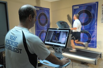 Karl Leonard, exercise physiologist at the Health and Wellness Center, monitors the running technique of Staff Sgt. Guadalupe Macias, Air Education and Training Command, Computer System Squadron, on his running efficiency lab Sept. 10 at Joint Base San Antonio-Randolph. (U.S. Air Force photo by Joel Martinez/ Released)