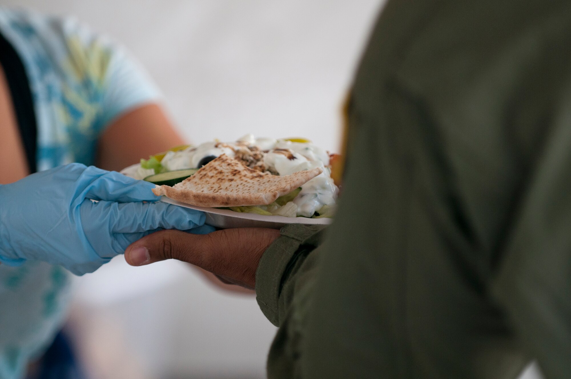 A volunteer brings a salad to a patron during the Ramstein Welfare Bazaar, Sept. 13, 2013, Ramstein Air Base, Germany. (U.S. Air Force photo/Senior Airman Jose L. Leon)