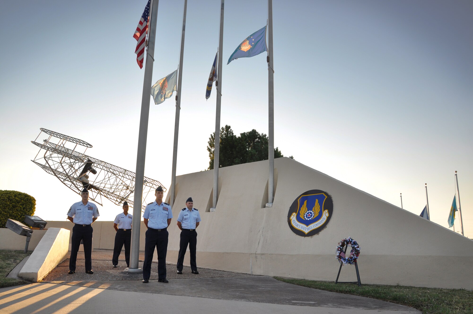 For 12 hours Wednesday, approximately 100 Team Tinker Airmen and civilians volunteered to stand 30-minute vigils at the flag pole located at the Wright Flyer Memorial Park on base to recognize America?s resolve to remain vigilant against the tyranny of terrorism and remember those who died in the attacks on Sept. 11, 2001. The unprovoked attack killed more people than the deadly assault on Pearl Harbor that brought forth the fury of America?s civilian and military might. Base leaders who took the first shift at 7:46 a.m. Wednesday are, from left, Chief Master Sgt. Jackie Green Jr., 966th Airborne Air Control Squadron; Chief Master Sgt. Shirley Jones, 72nd Mission Support Group; Col. Jay Bickley, 552nd Air Control Wing commander; and Col. Stephen Wood, 72nd Air Base Wing vice commander. See related story page 4. (U.S. Air Force photo by Brion Ockenfels)