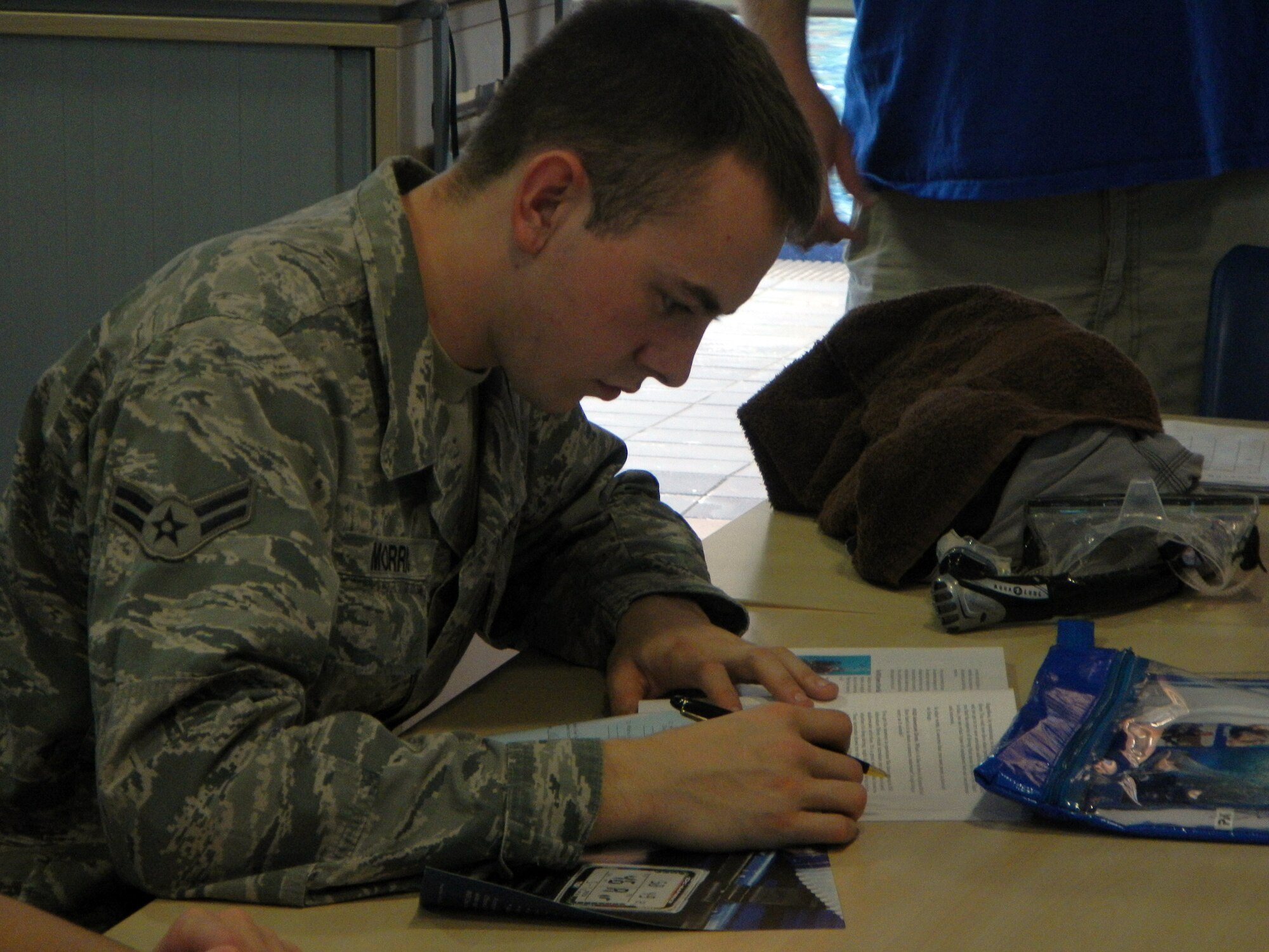 Airman 1st Class Mark Morris, 86th Civil Engineer Squadron firefighter, concludes a chapter review during the knowledge portion of the scuba diving certification course, Sept. 11, 2013, Ramstein Air Base, Germany. (U.S. Air Force photo/Senior Airman Caitlin Guinazu)