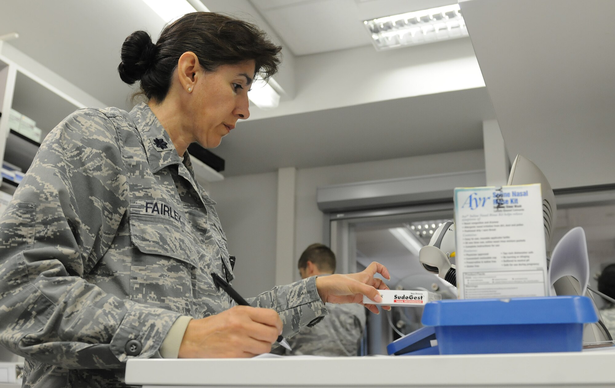 Lt. Col. Christine Fairley, 86th Medical Support Squadron diagnostic and therapeutic flight commander, prepares medicine for a KMC resident getting medication through the Self-Initiated Care Kit program, Sept. 13, 2013, Ramstein Air Base, Germany. The objective of the S.I.C.K. program is to honor families’ time and resources by reducing appointments for over-the-counter medications. (U.S. Air Force photo/Airman 1st Class Holly Mansfield)  