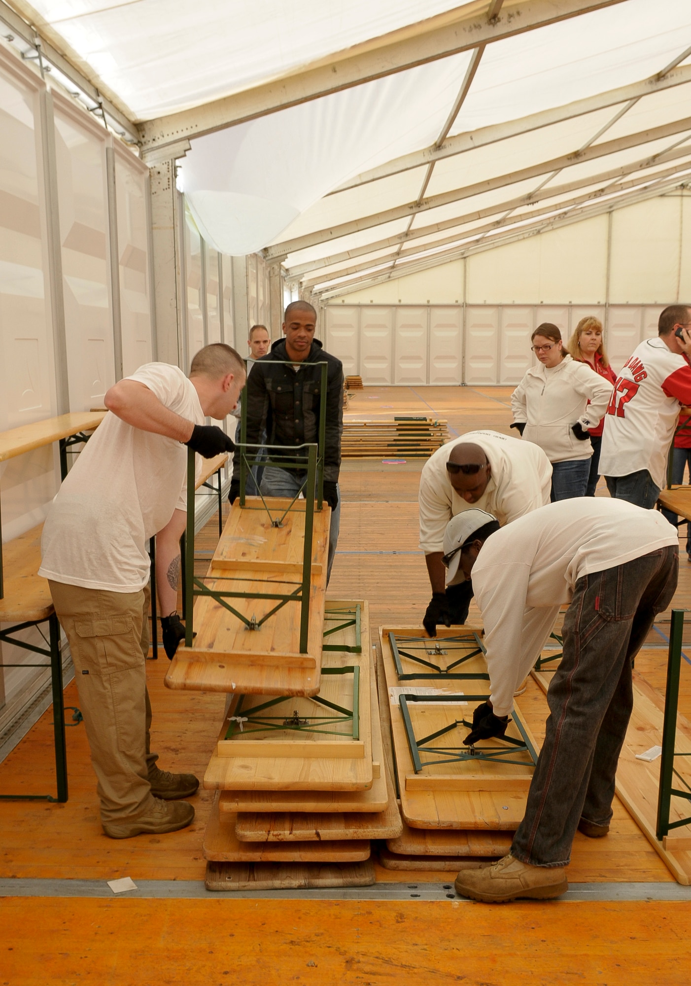 Volunteers setup tables and benches at the Ramstein Welfare Bazaar, Sept. 9, 2013, Ramstein Air Base, Germany. (U.S. Air Force photo/Senior Airman Jose L. Leon)