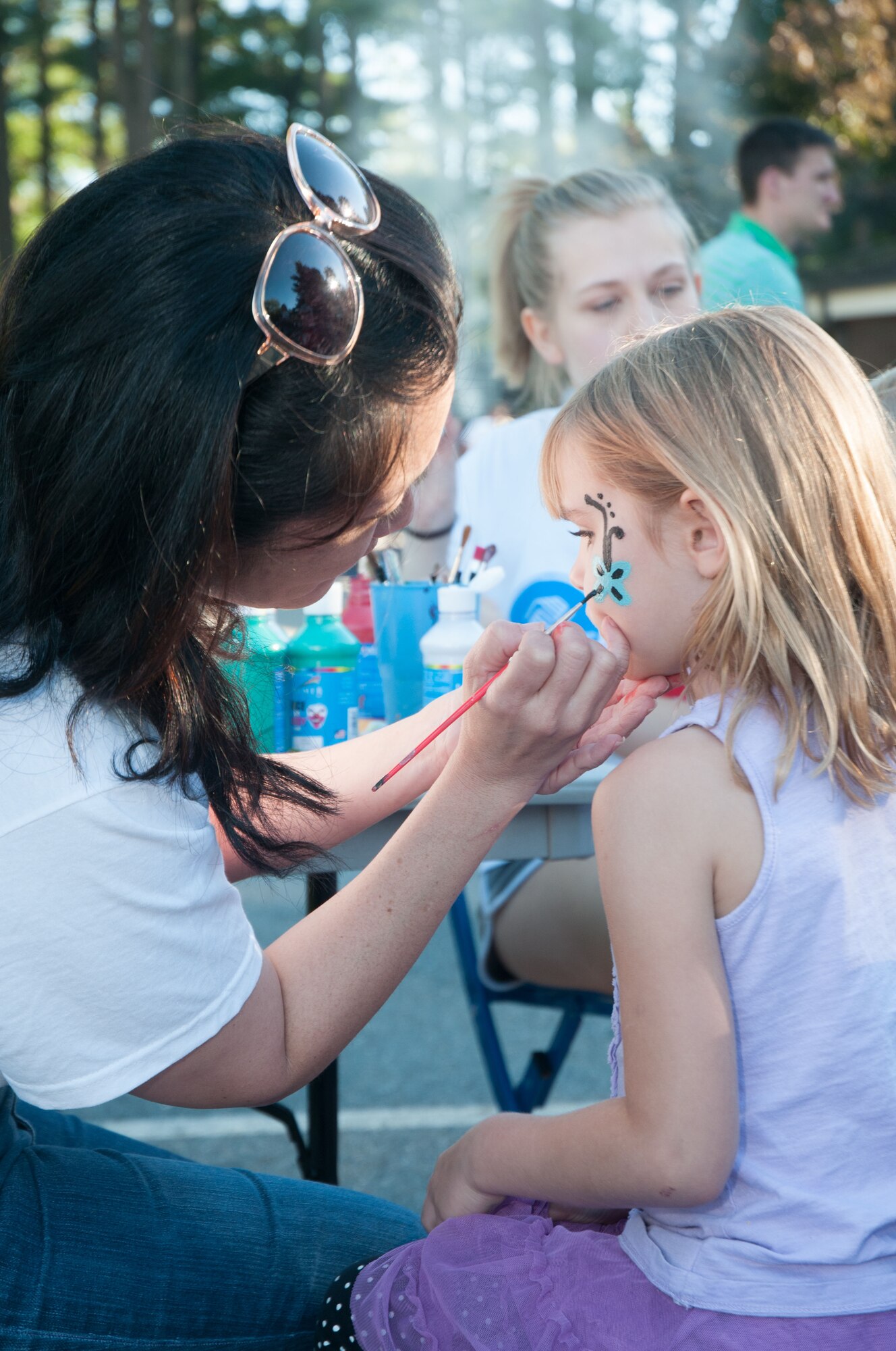 HANSCOM AIR FORCE BASE, Mass. -- Robyn Endo, Airman and Family Readiness Center director, paints Kaitlyn Johnson's face during the Boys and Girls Club Day for Kids at Castle Park Sept. 18. Each September, a special day is chosen to celebrate children. In addition to face painting, hot dogs, hamburgers and other free events for base families were available. (U.S. Air Force photo by Mark Herlihy)
