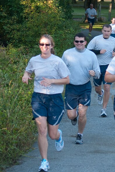 HANSCOM AIR FORCE BASE, Mass. – Members of Theater Battle Management Control Division, led by (left to right) Capt. Kimberly Smith, Lt. Col. Blake Farley and 1st Lt. Joe Silvio run through Castle Park during the Hanscom Sports and Fitness Center’s Back to School Fun Run Sept. 18. The top finishers in the male category were Billy Preston 19:38; 2nd Lt. Ryan Dotson, 19:58; Robert Elliott, 20:51. The top female finishers were Capt. Carolyn Cruz, 19:38; Stephanie Sherman 25:56; Capt. Kimberly Smith, 26:45. (U.S. Air Force photo by Rick Berry) 