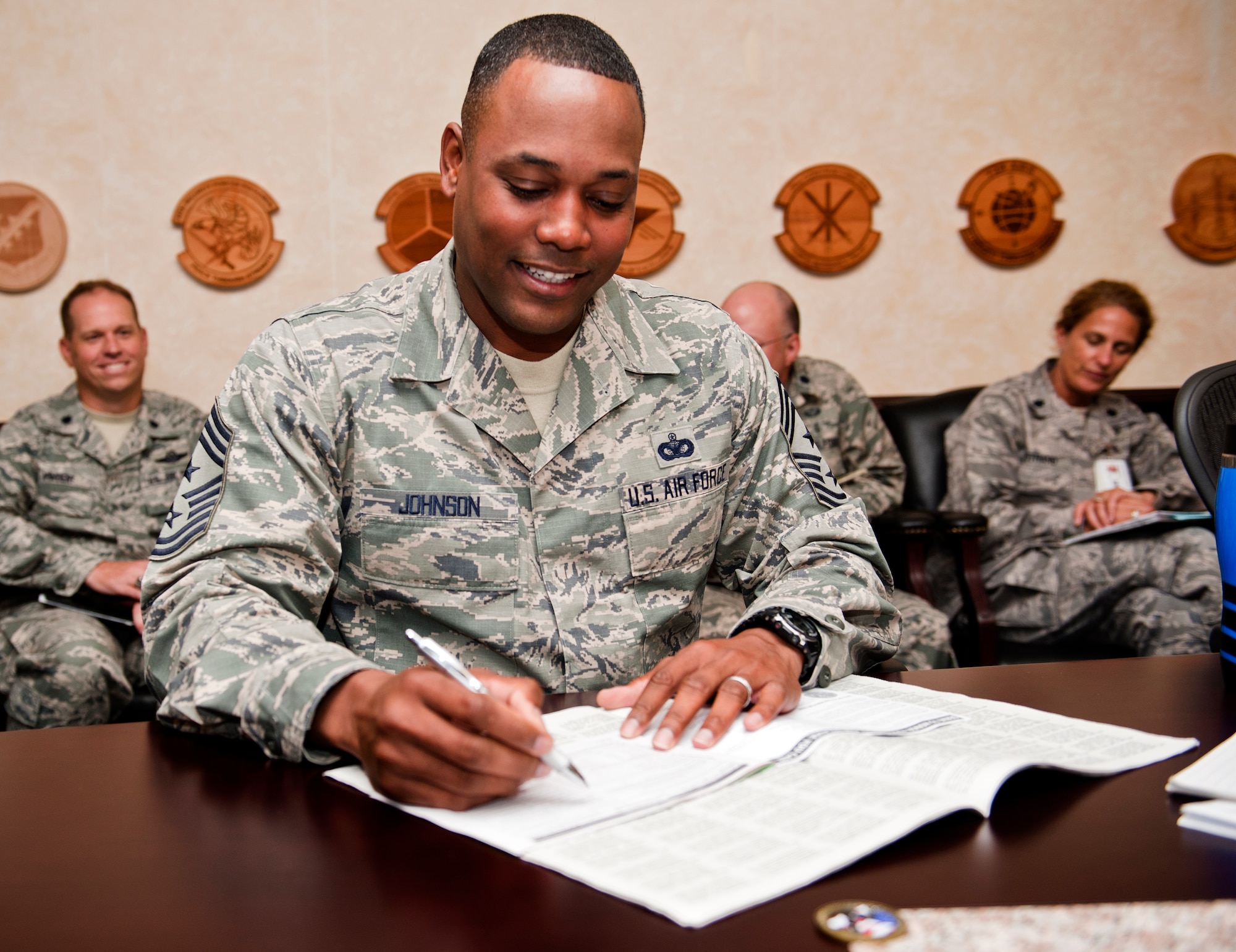 Chief Master Sgt. Anthony Johnson, 39th Air Base Wing command chief, makes Incirlik Air Base's first Combined Federal Campaign-Overseas donation, Sep. 19, 2013, at Incirlik AB, Turkey. CFC is the only Department of Defense authorized solicitation of federal employees in their workplaces on behalf of approved charitable organizations. (U.S. Air Force photo by Senior Airman Daniel Phelps/Released)