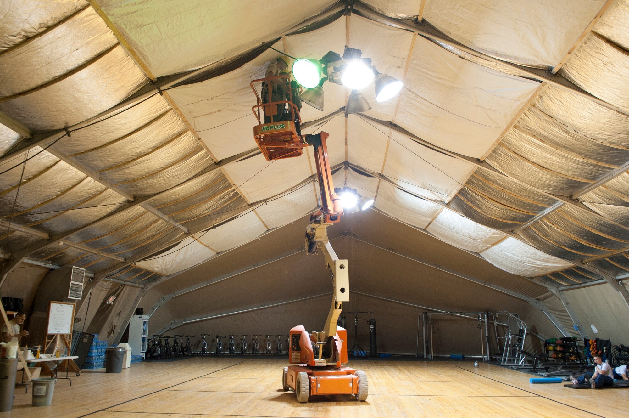 Members of the 376th Expeditionary Civil Engineer Squadron install insulation into the main fitness center annex at Transit Center at Manas, Kyrgyzstan, Sept. 6, 2013. The structural engineers reinforced the fiberglass insulation to protect it from sports activities.  (U.S. Air Force photo/Staff Sgt. Robert Barnett)