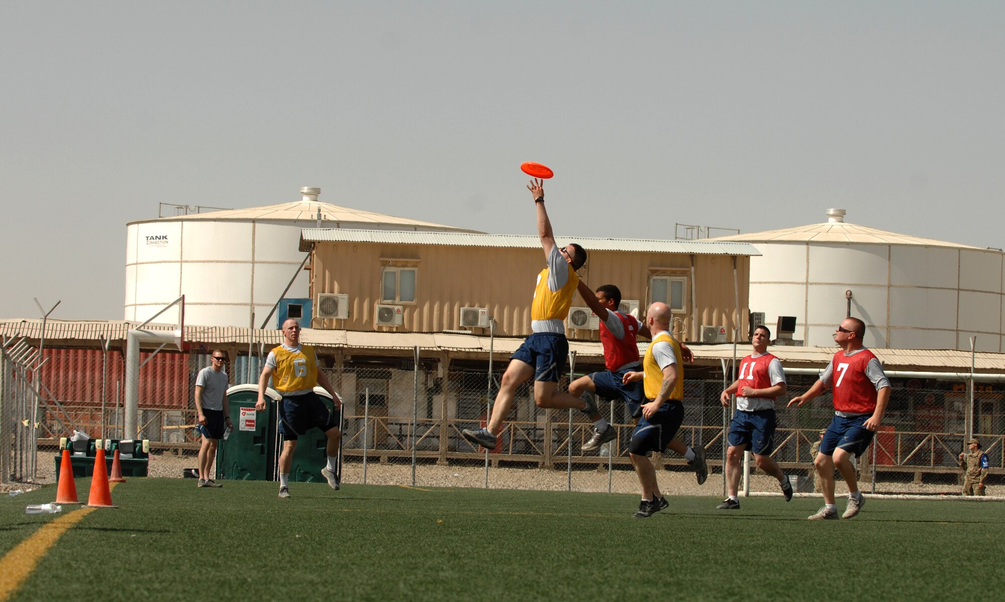 Airmen from across Kandahar Airfield, Afghanistan, play Ultimate Frisbee at the boardwalk as part of celebrations for the Air Force birthday here Sept. 18, 2013. Airman at Kandahar celebrated the Air Force's 66th birthday, with a sports day and ceremony. During the events of the day, Airmen still accomplished the mission, as F16s launched and patrolled to provide close air support, C-130J Hercules' delivered cargo to far-flung forward operating bases and patients to higher levels of care, and MC-12, E-11, MQ-1 and MQ-9 aircraft provide intelligence, surveillance, reconnaissance and communication support to ISAF and Afghan forces throughout Afghanistan. (U.S. Air Force photo by Senior Airman Jack Sanders)
