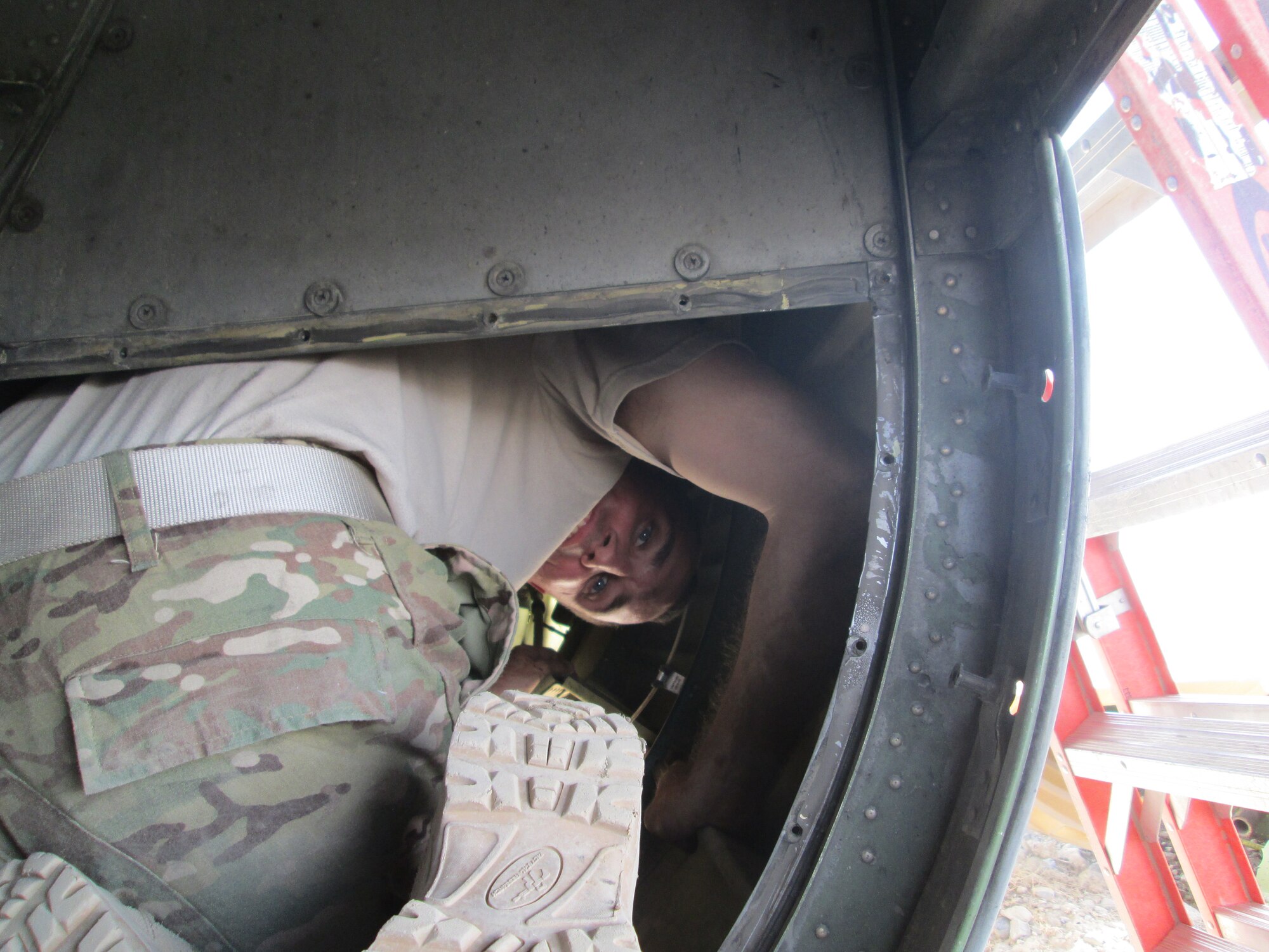 1st Lt. Eric Yerly's job as a depot liaison engineer (DLE) sometimes requires him to fit into small spaces to fix aircraft problems or find their root causes.  Yerly is currently deployed to Southwest Asia where he is one of four DLEs responsible for the safety of flight for all the aircraft in Air Force Central Command's area of responsibility.  At home station, Yerly responds to Air Force wide C-130 technical resistance requests (TARS) at the Air Force Life Cycle Management Center at Robins AFB, Ga.   TARS are most commonly submitted when aircraft maintainers run into an aircraft issue that their technical orders (TOs) do not address.  Having an engineer on hand in a deployed location ensures that issues not addressed in the (TOs) can be handled on the spot.  (Courtesy photo)