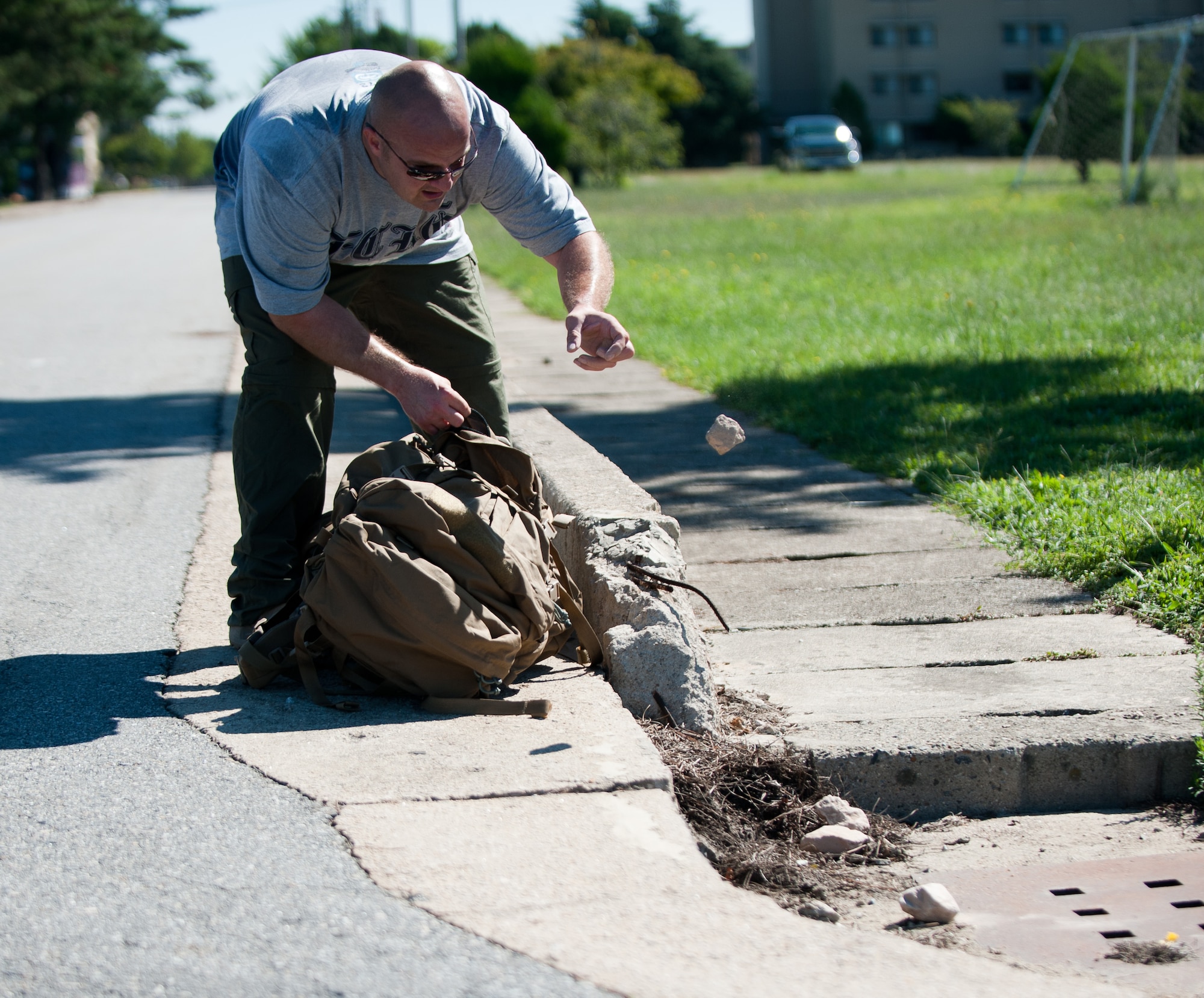 Tech. Sgt. Mark Gostomski, 8th Civil Engineer Squadron, lightens his ruck sack after completing the Kunsan Prisoner of War and Missing In Action Ruck March at Kunsan Air Base, Republic of Korea, Sept. 16, 2013. Gostomski marched five miles with 40 pounds in his ruck sack to honor prisoners of war and those missing in action. (U.S. Air Force photo by Senior Airman Clayton Lenhardt/Released)