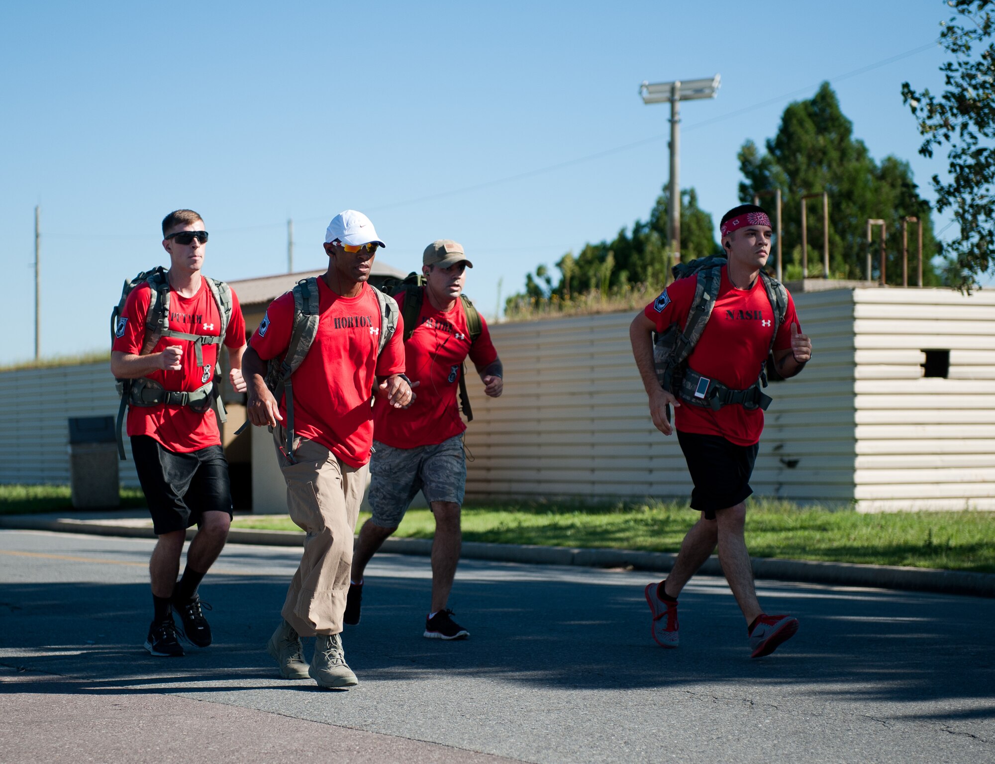 The 8th Security Forces Squadron team jogs a portion of the Kunsan Prisoner of War and Missing In Action Ruck March at Kunsan Air Base, Republic of Korea, Sept. 16, 2013. Their team was the first team to finish the march with a time of one hour, 15 minutes. (U.S. Air Force photo by Senior Airman Clayton Lenhardt/Released)