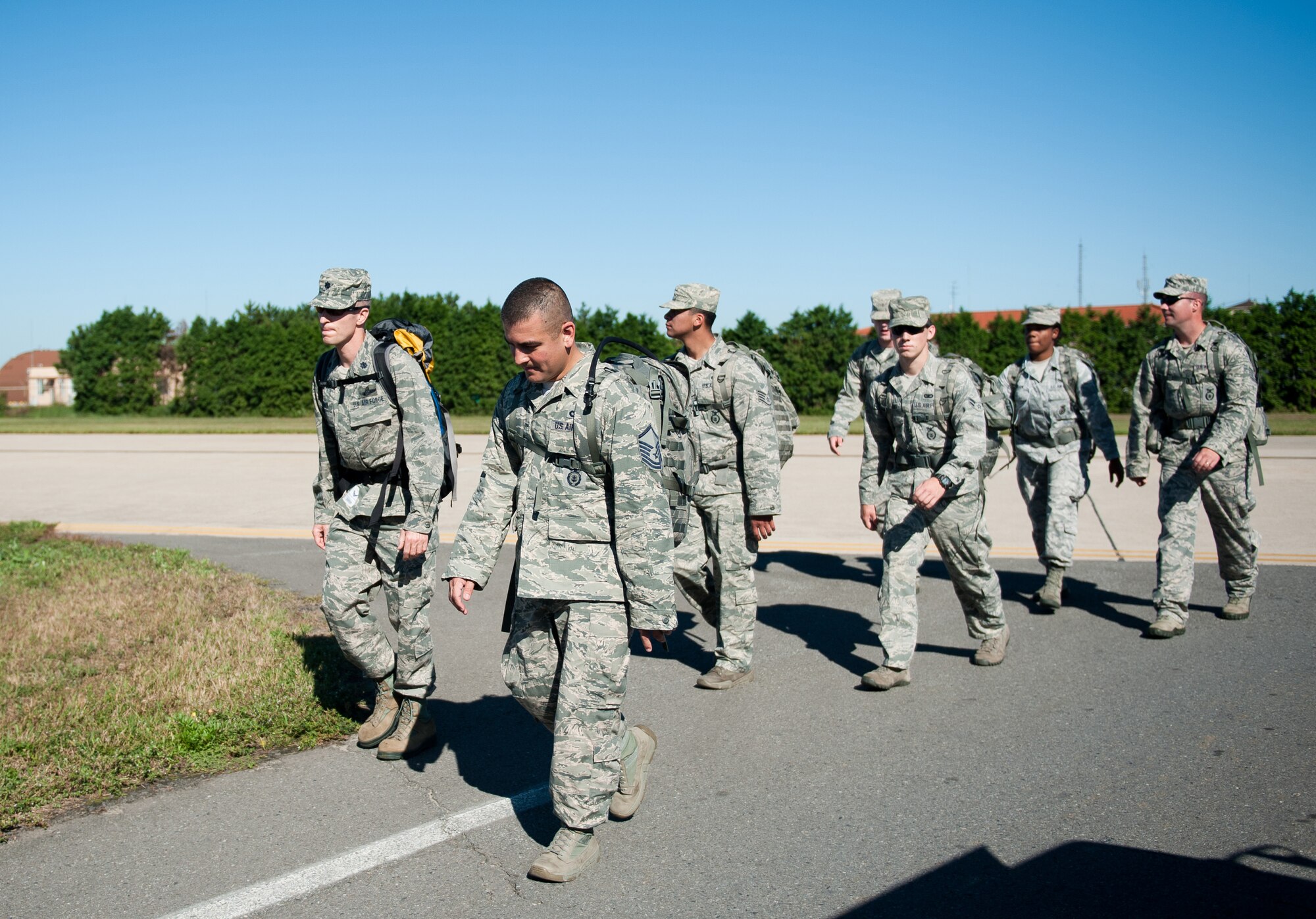 Wolf Pack Airmen take part in the Kunsan Prisoner of War and Missing In Action Ruck March at Kunsan Air Base, Republic of Korea, Sept. 16, 2013. The Wolf Pack started a week of honoring prisoners of war and those missing in action with a five mile march while carrying at least 40 pounds. (U.S. Air Force photo by Senior Airman Clayton Lenhardt/Released)